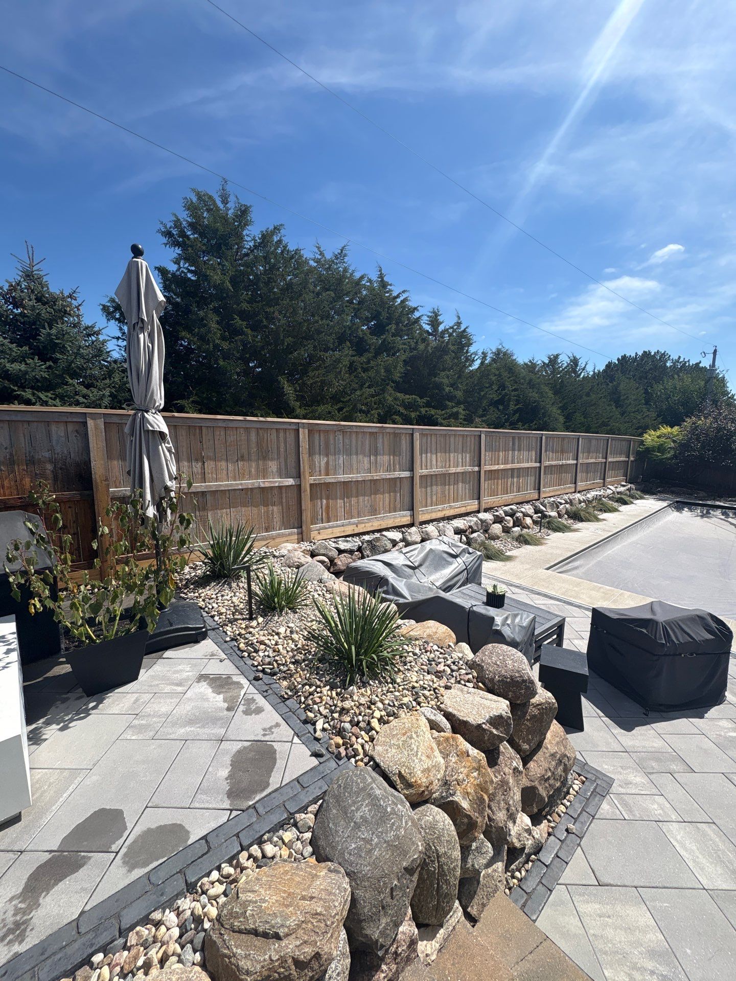 Custom Privacy Fence and Paver Patio Installation in Sioux Falls by Select Painting, Coatings & Garage Cabinets