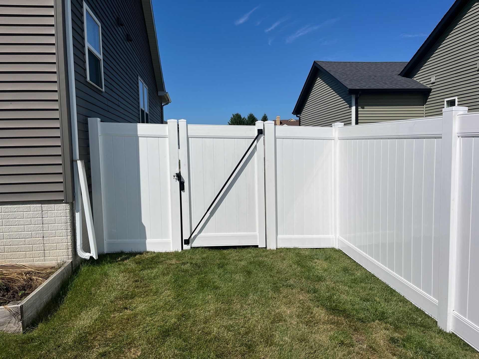 New Vinyl Privacy Fencing and Gates for Waterloo Residential Backyard by Perfect Picket Fence and Stain