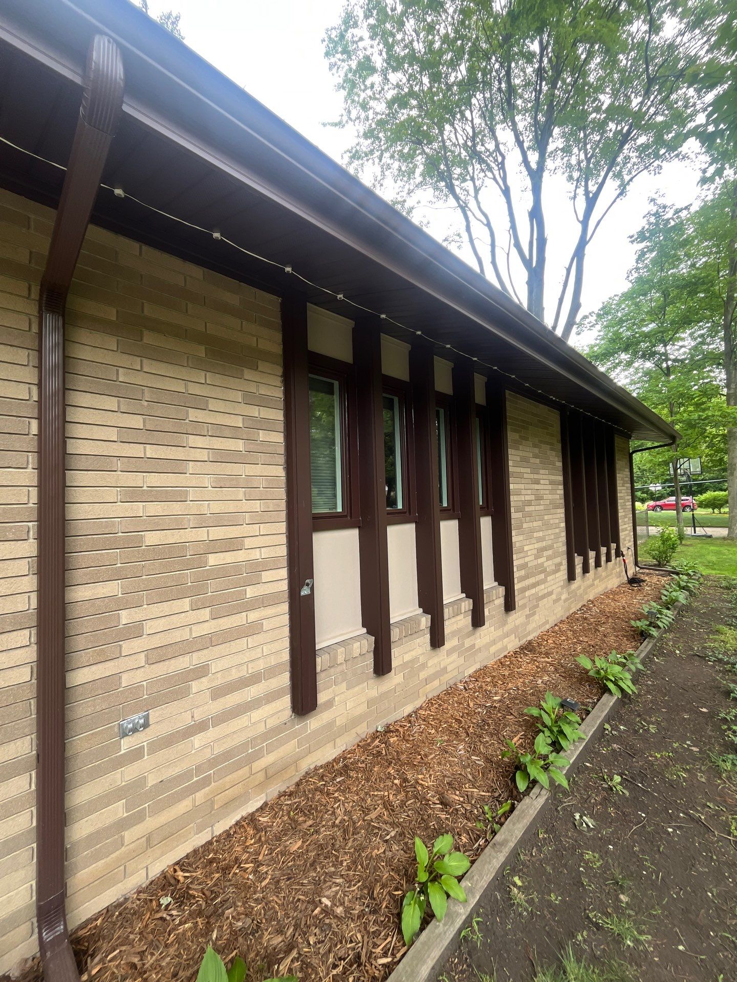 Dark Brown Window Installation for Midland Brick Ranch Home by Great Lakes Home Design LLC