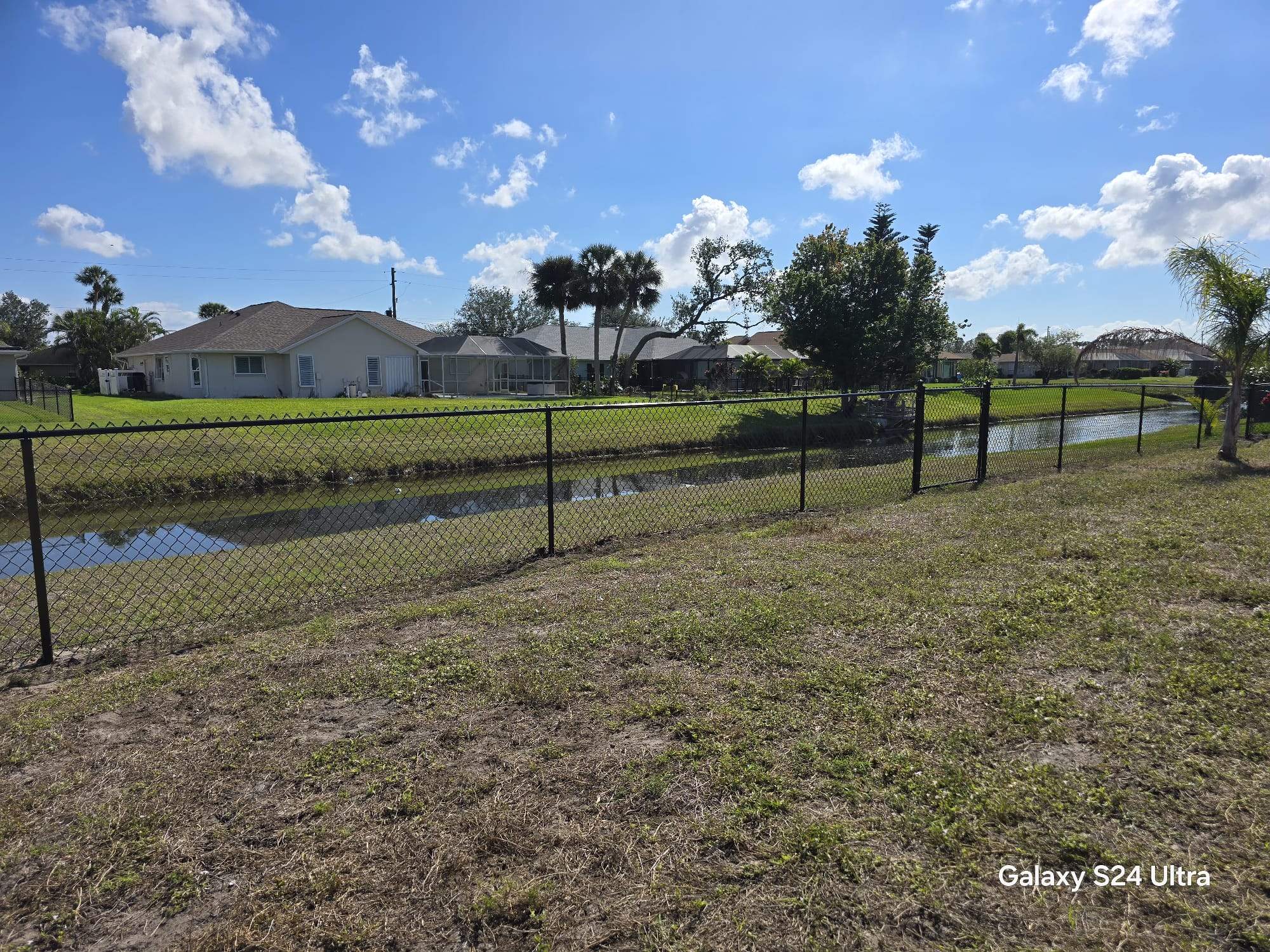 Waterfront Black Chain Link Fence Installation in Rotonda West by True Fence LLC