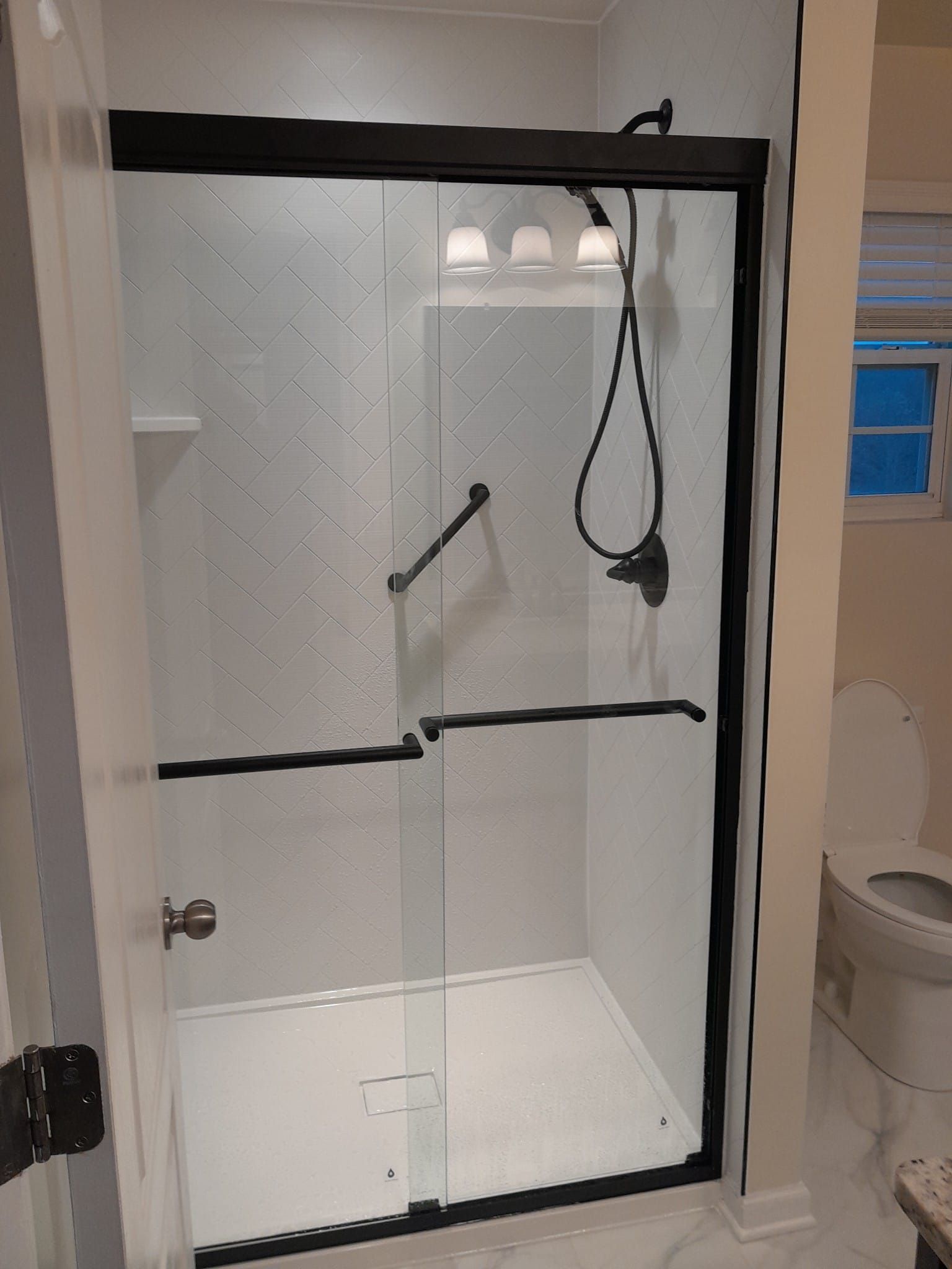 Shower remodel using Maintenance free wall system and shower pan with glass door by Window Depot of Annapolis