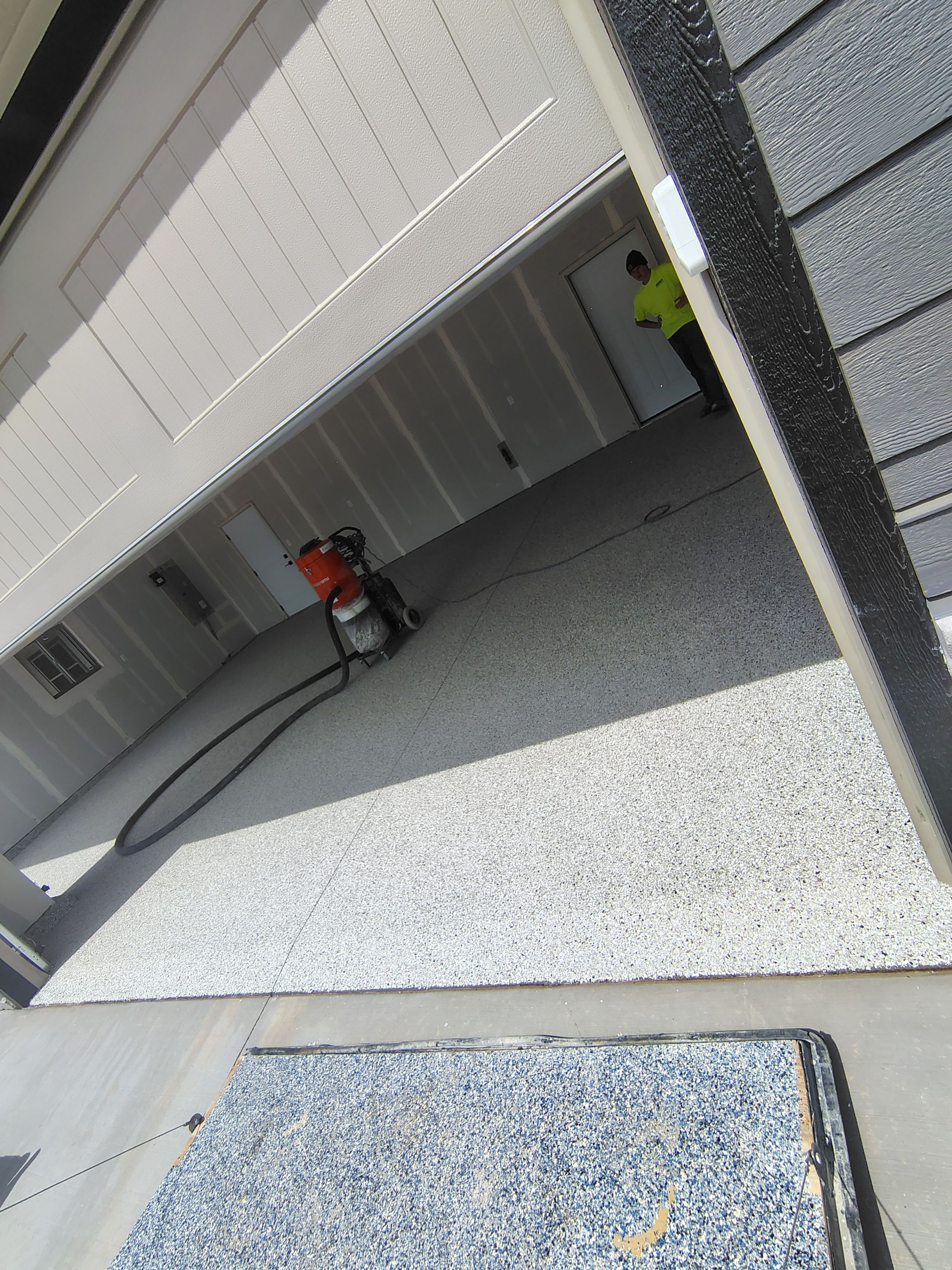 Speckled Epoxy Garage Floor Coating Installation in Sioux Falls by Select Painting, Coatings & Garage Cabinets