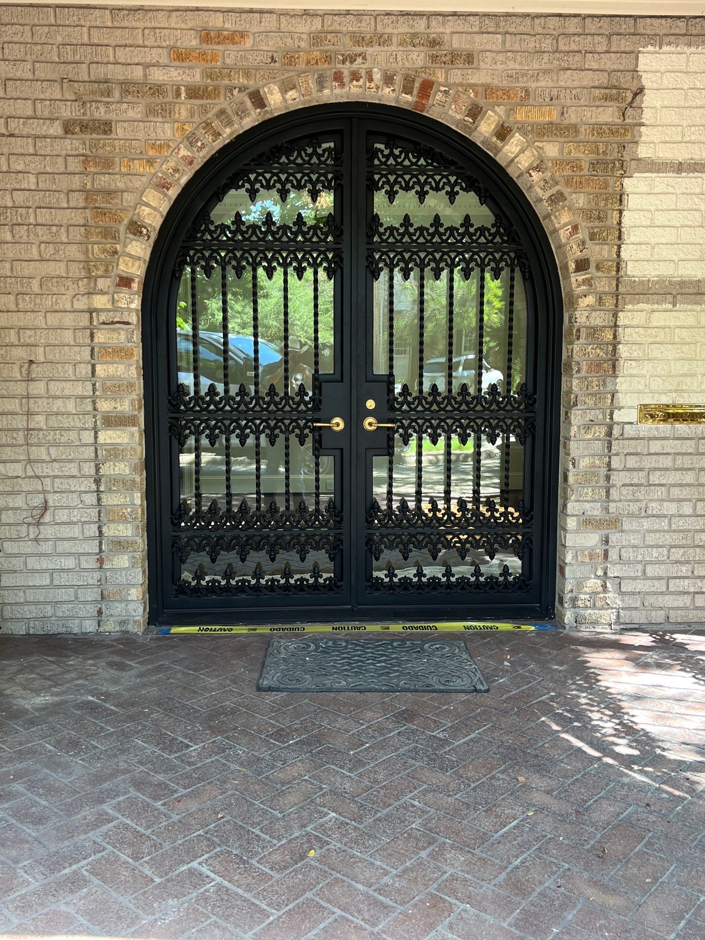Custom Arched Black Wrought Iron Double Door Installation in Dallas by Solara Custom Living