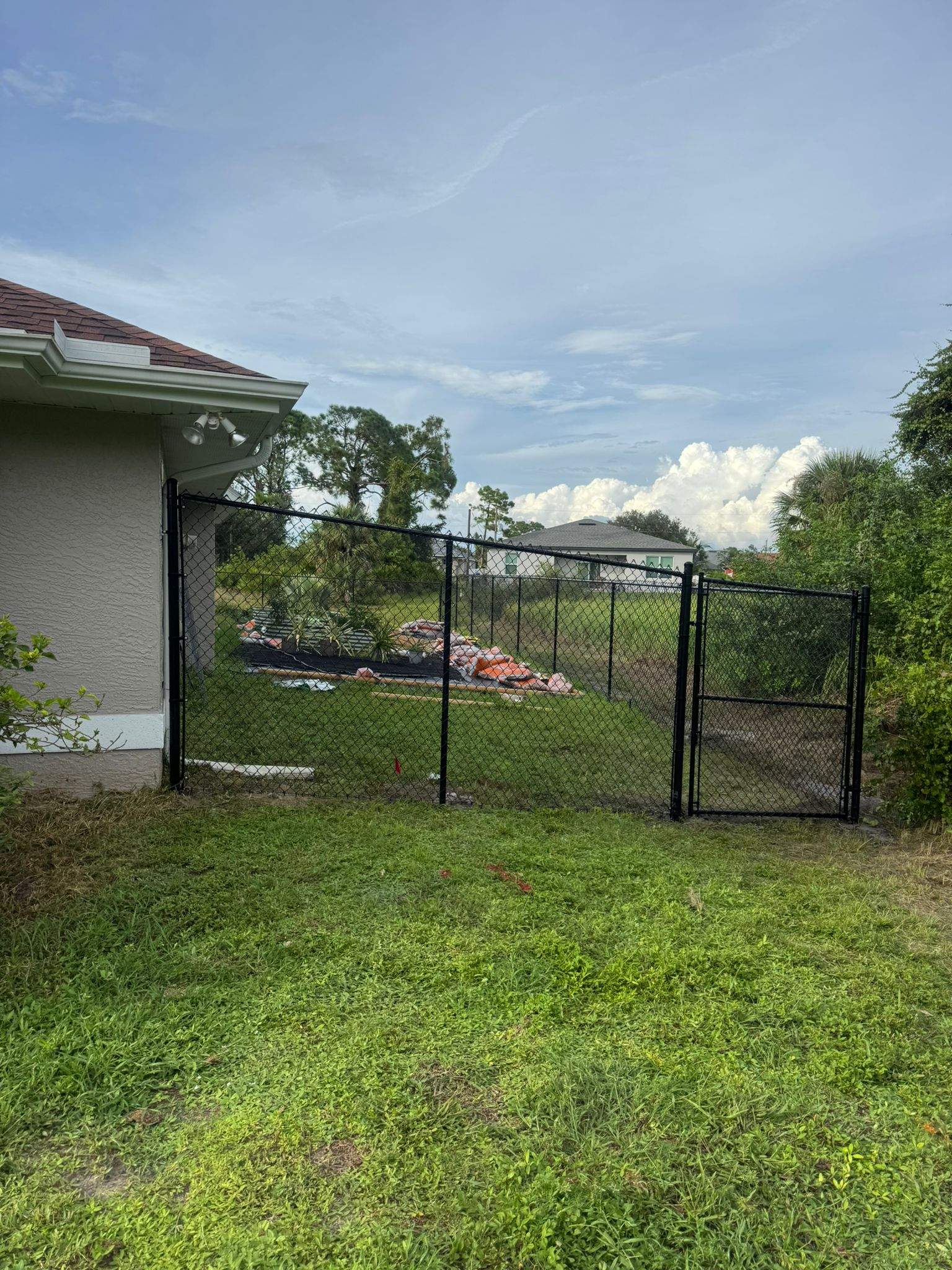 Black Vinyl-Coated Chain Link Fence and Gate Installation in North Port by True Fence LLC