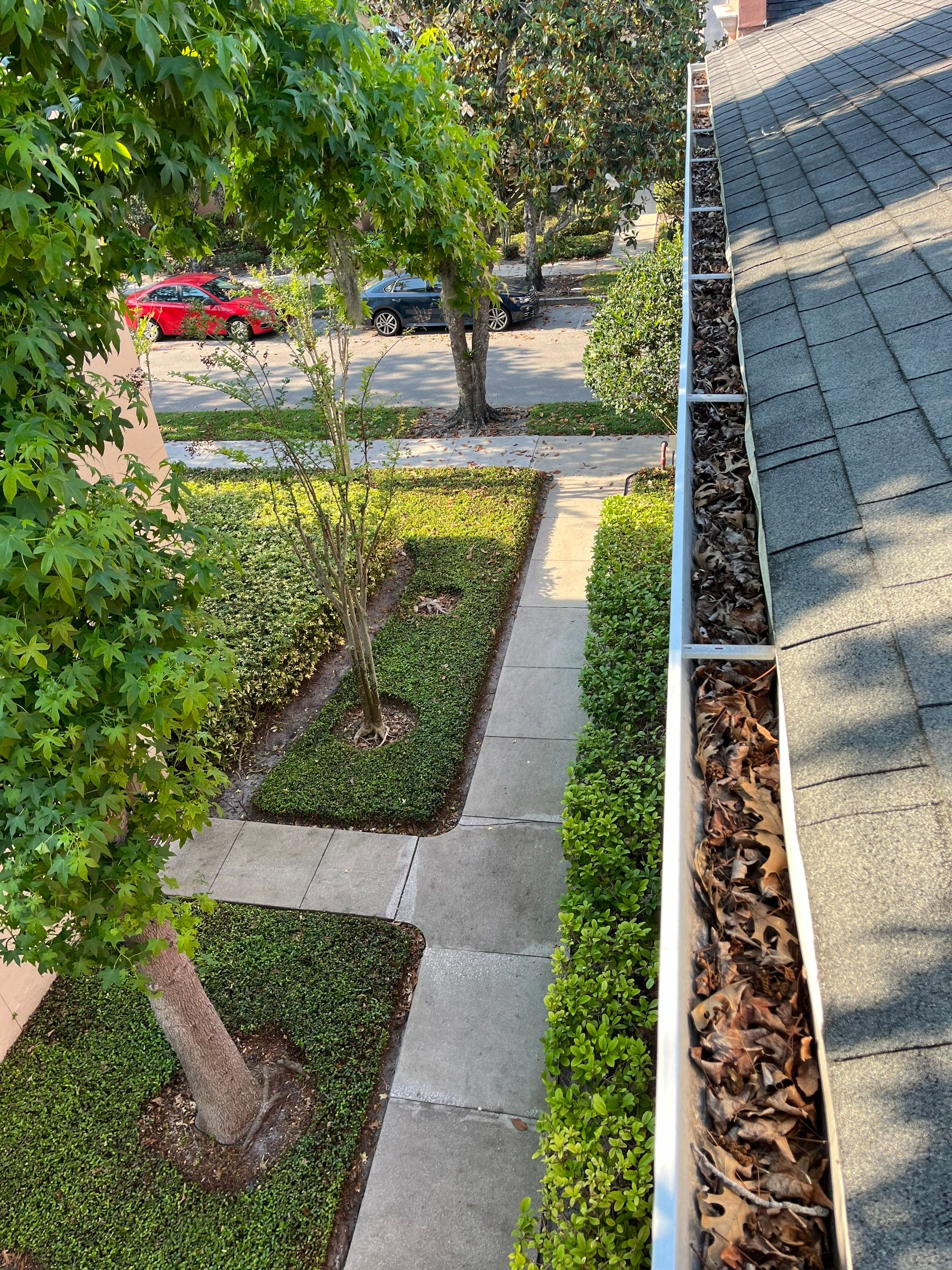 Commercial gutter cleaning Orlando, FL before photo with filled gutters