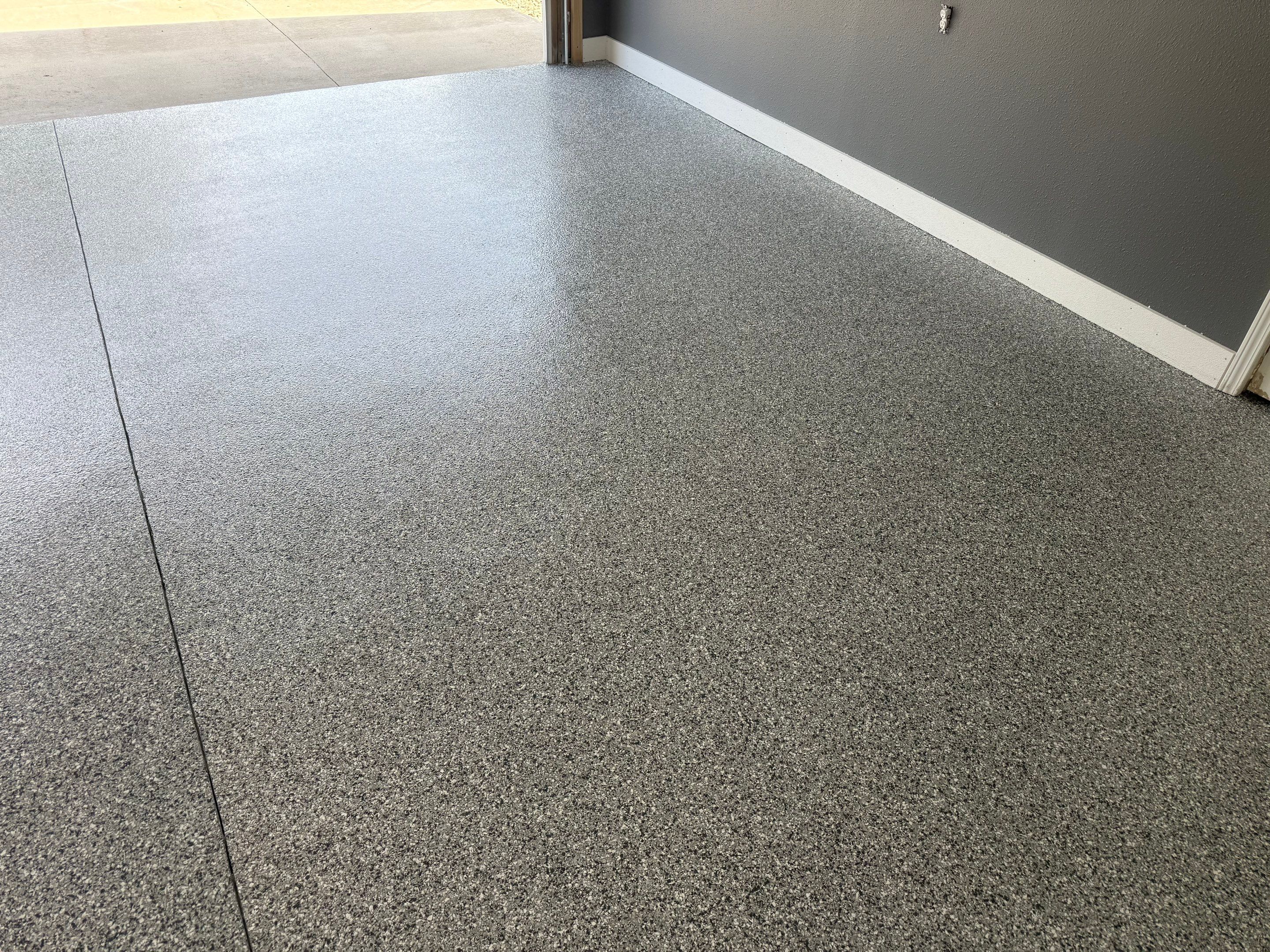 Custom Garage Floor Coating and Backyard Patio Refinishing in Tyndall by Select Painting, Coatings & Garage Cabinets