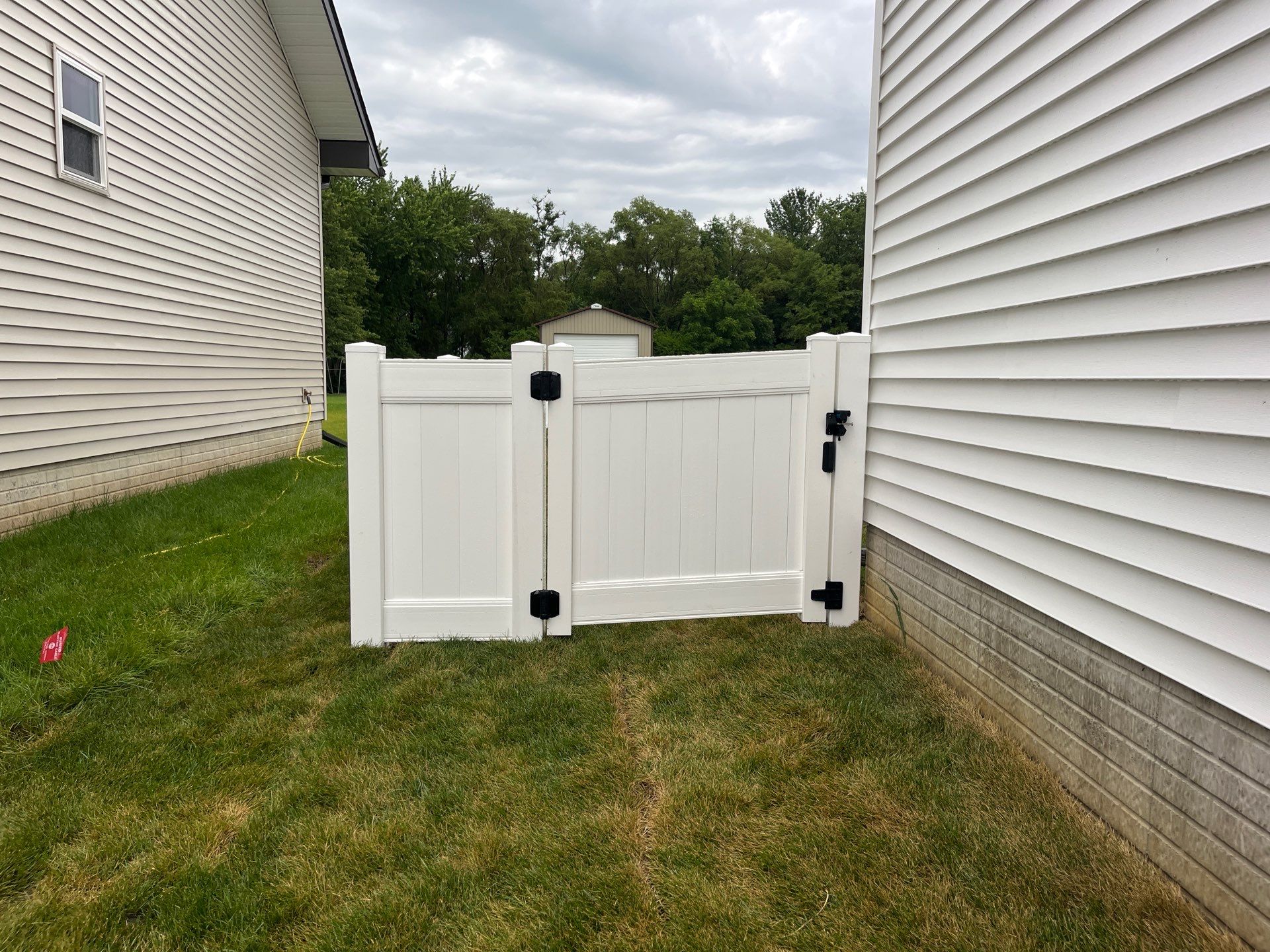 White Vinyl Privacy Fence With Pet Window in Cedar Falls by Perfect Picket Fence and Stain