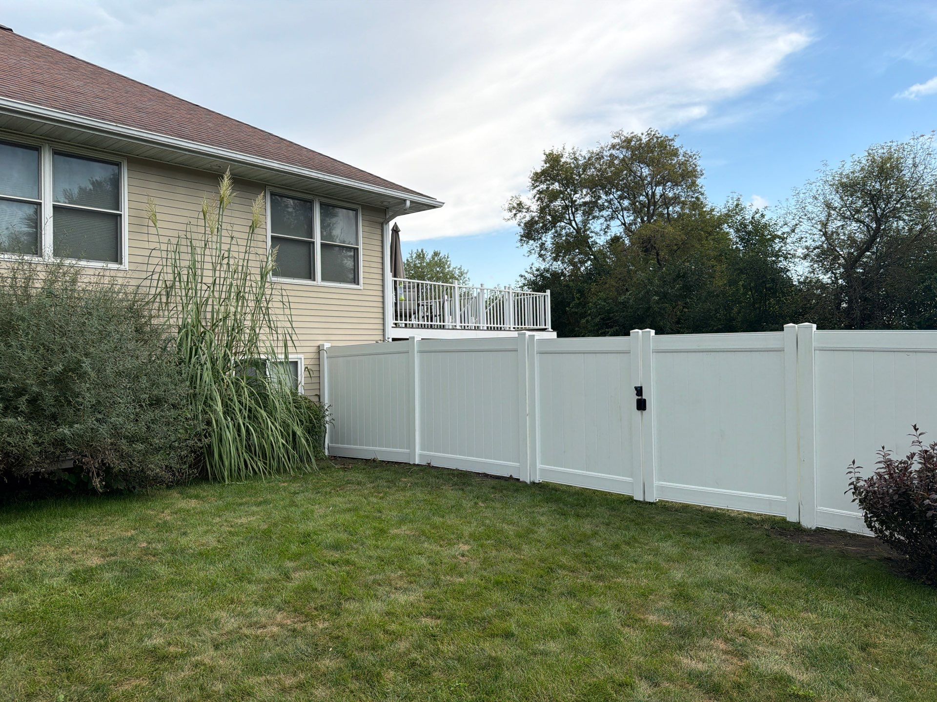 White Vinyl Privacy Fence Installation in Raymond, IA by Perfect Picket Fence and Stain