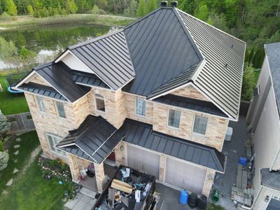 Residential Roofing Installation using 16" Standing Seam Panels