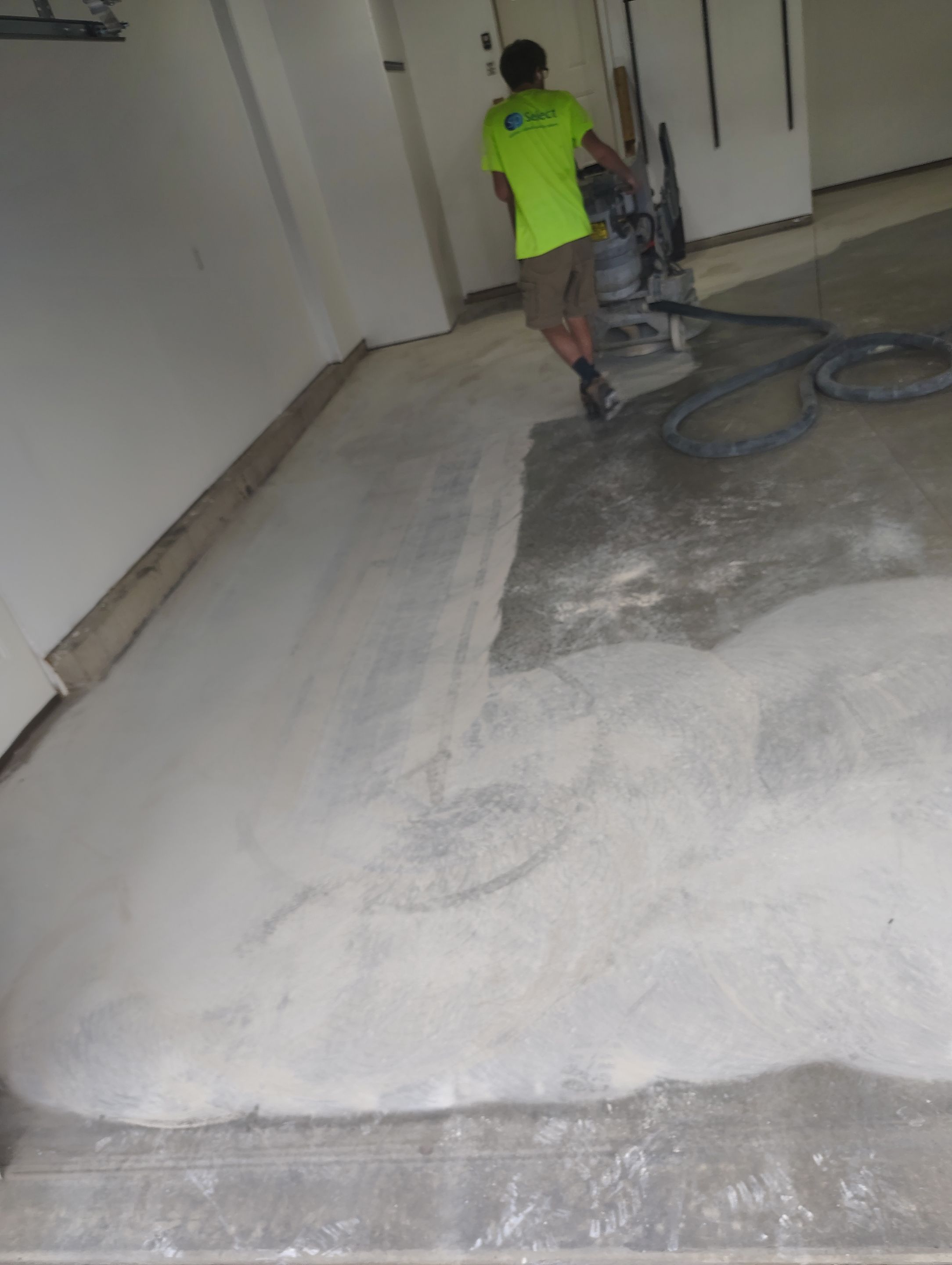 Sioux Falls Garage Floor Transformation With Gray Speckled Epoxy Coating by Select Painting, Coatings & Garage Cabinets