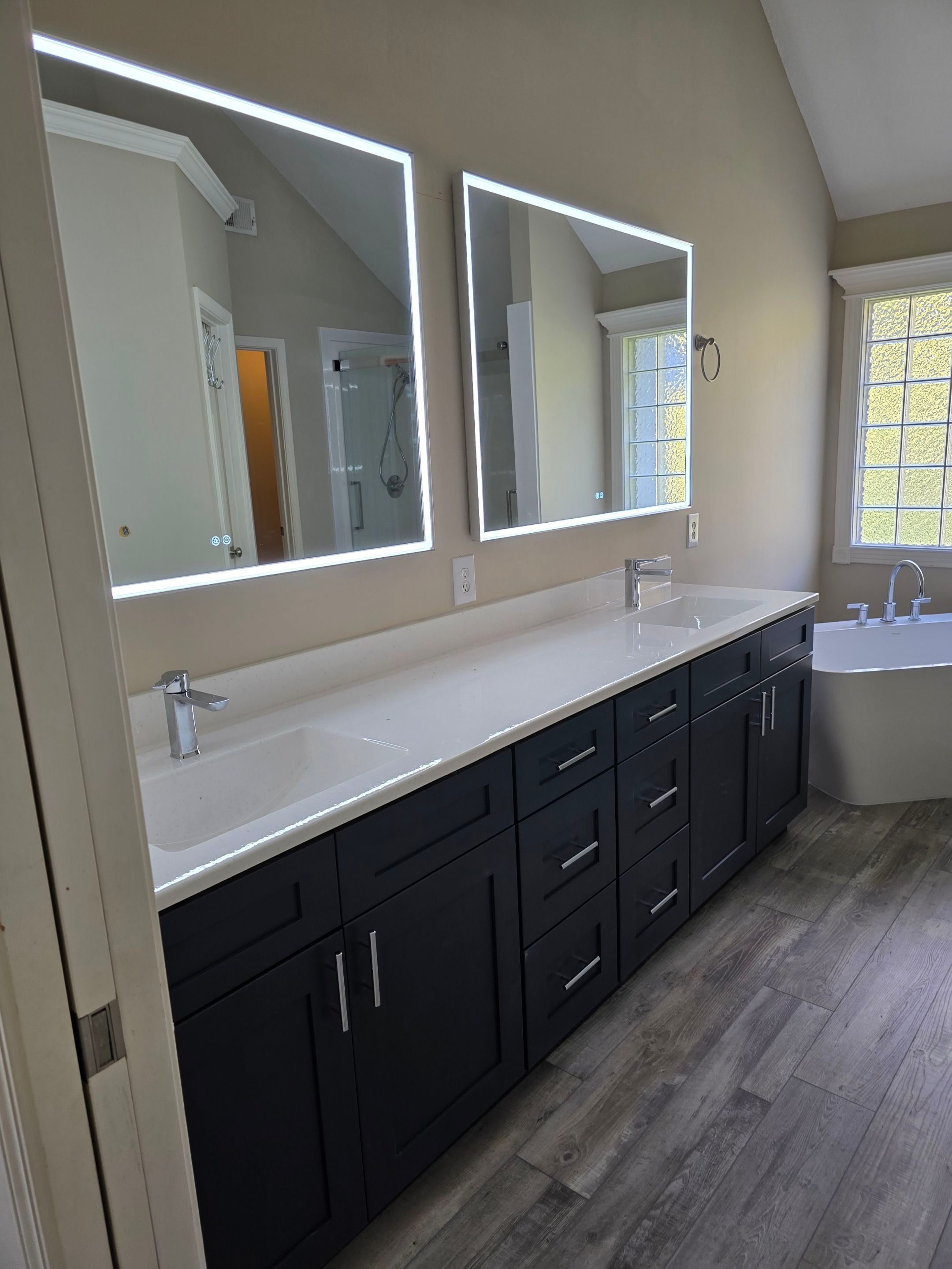 Full bathroom remodel with Artus lighted mirrors, Waltz bathtub and Mercury doors by The Shower Company