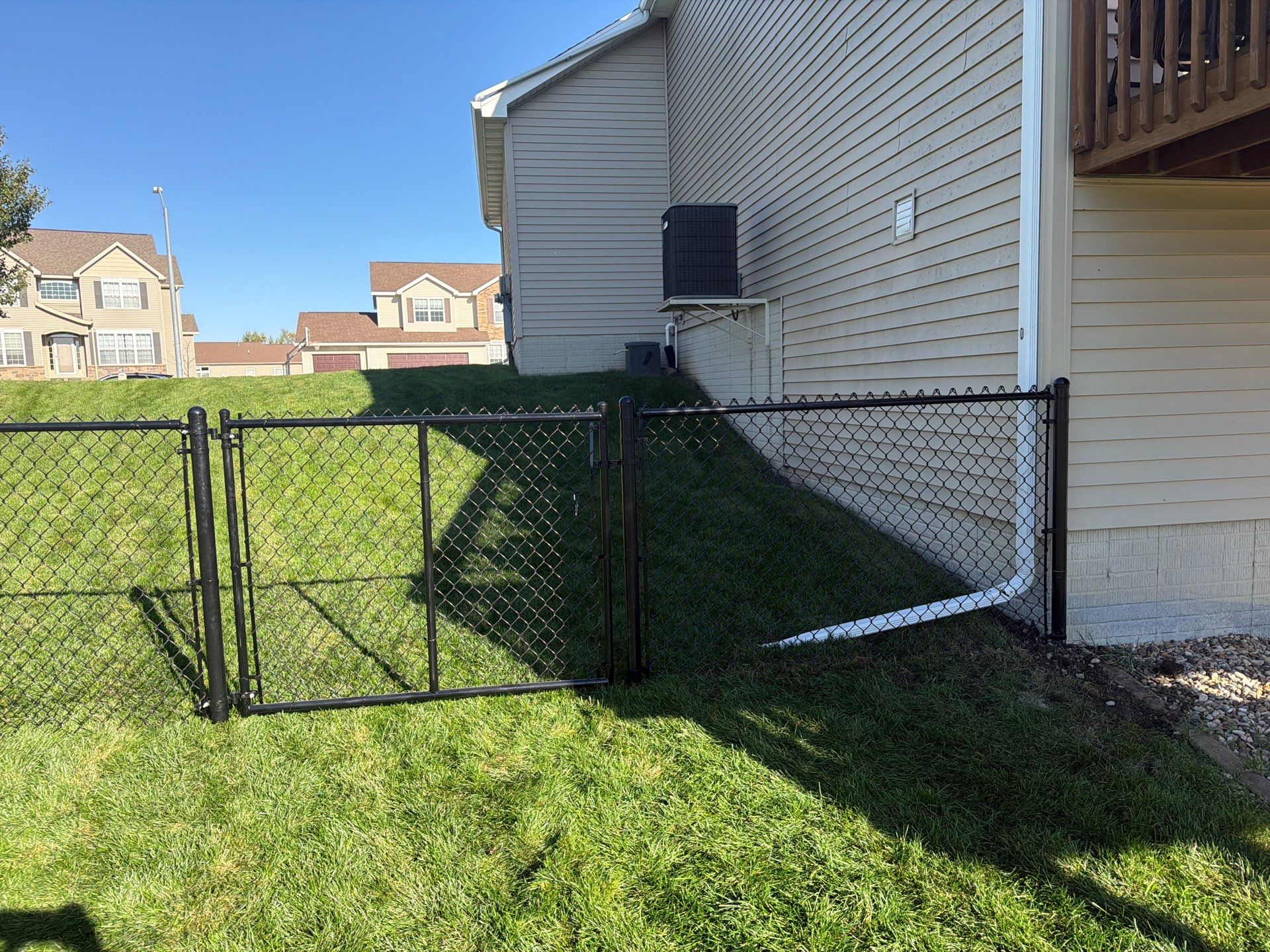 Black Vinyl-Coated Chain Link Fence Installation in Cedar Falls by Perfect Picket Fence and Stain
