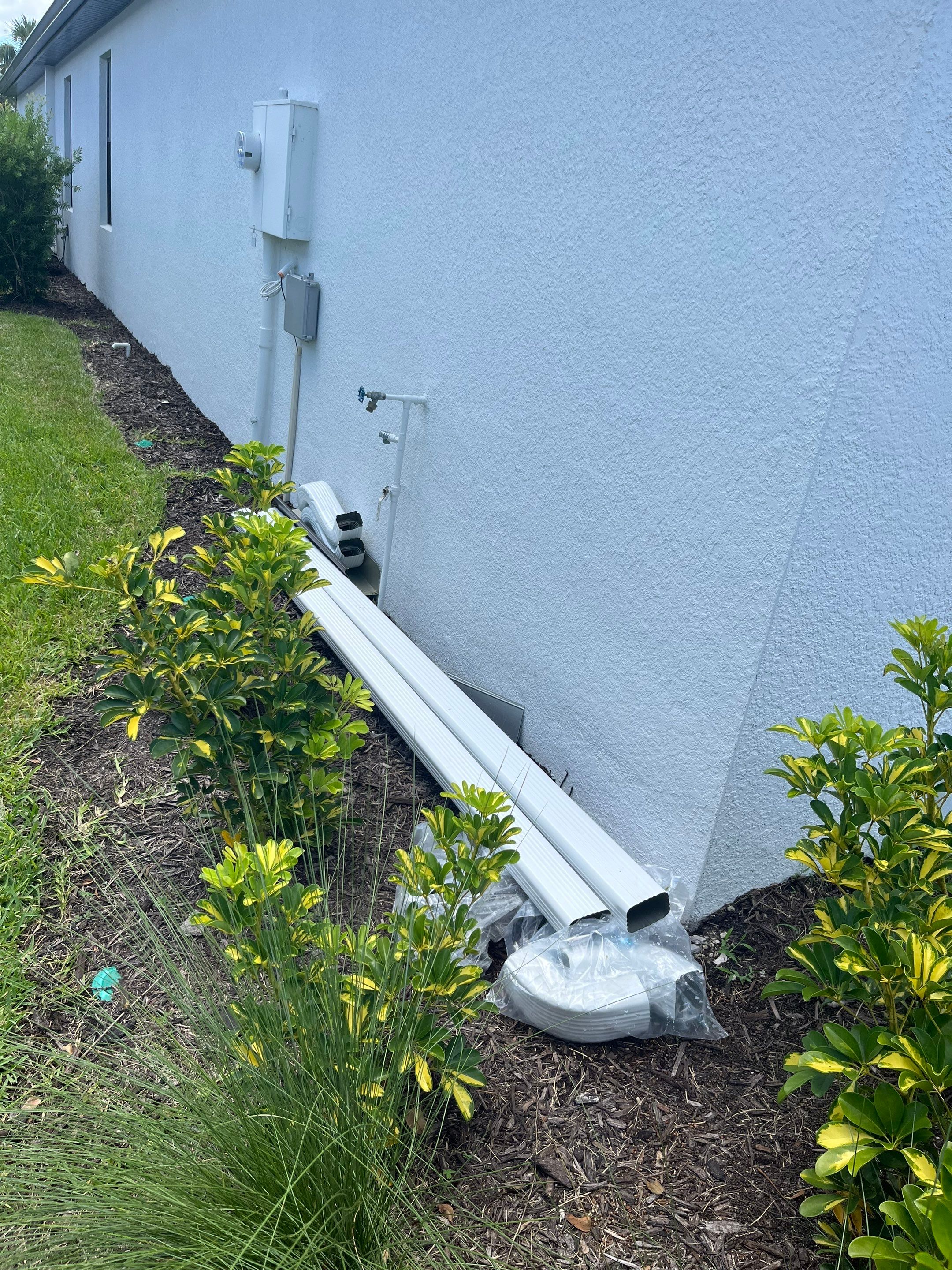 Dark Bronze Gutters and White Downspouts in Sarasota FL by Gutter Professors