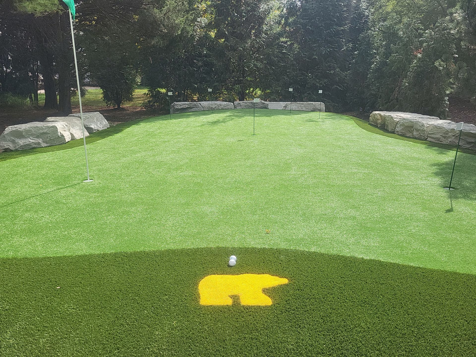 Custom Backyard Putting Green around Landscape Boulders in Hilliard by Southwest Greens Midwest
