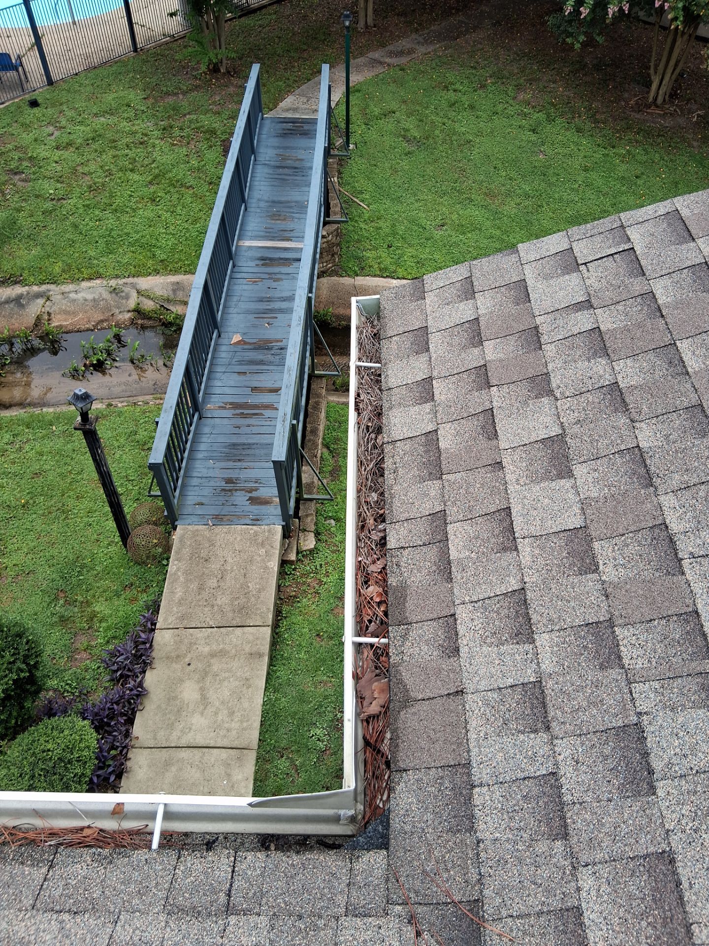 Commercial gutter cleaning Gulfport & Biloxi, MS before photo with filled gutters