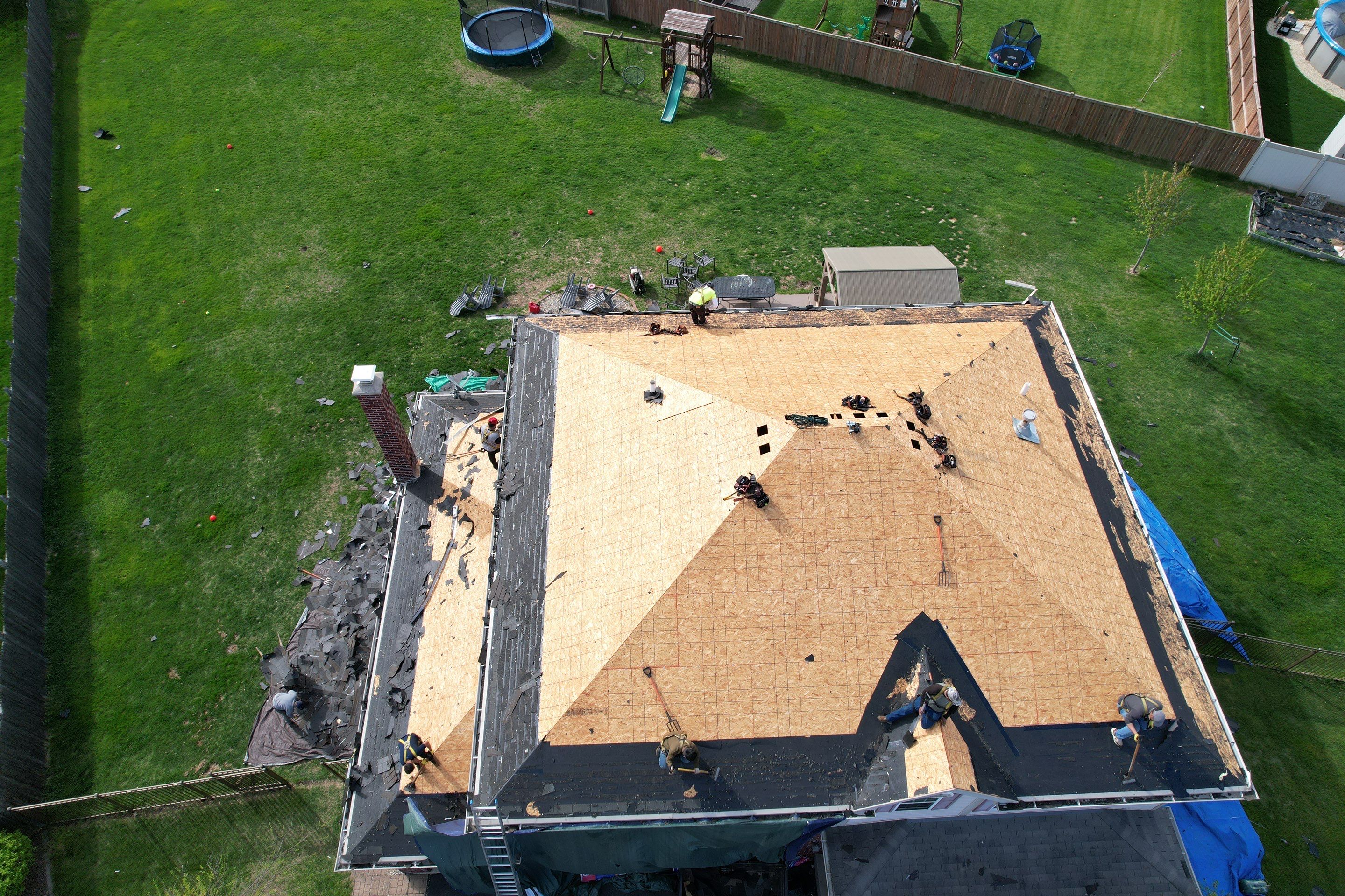 New black gutters and roof by Optimal Home Improvement 