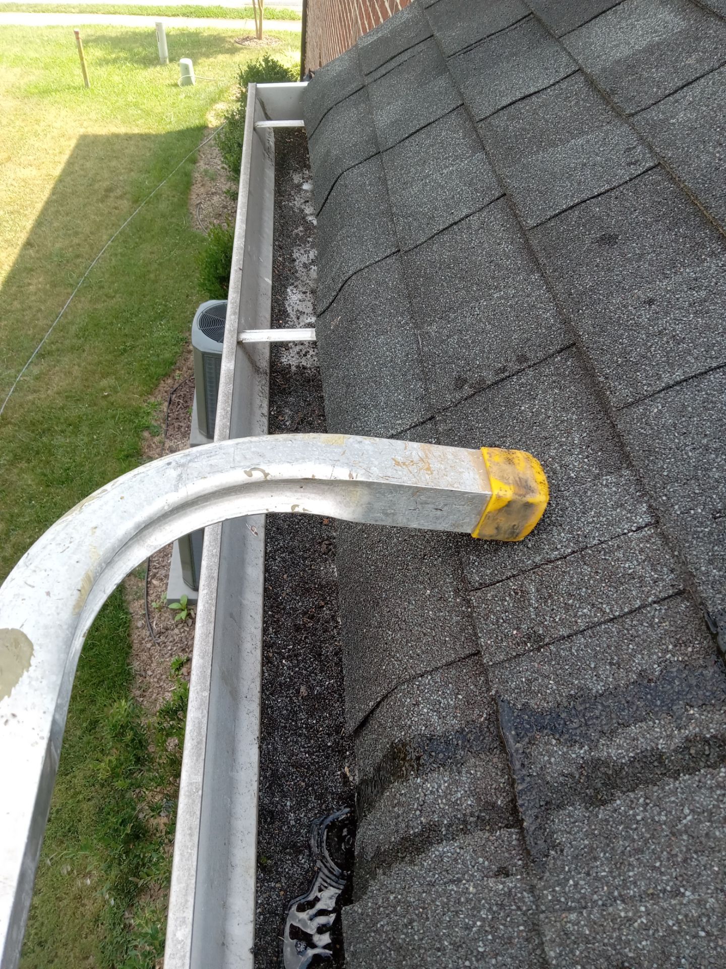 pressure washing gutters and roof removing debris mold and dirt restoring surfaces to clean condition