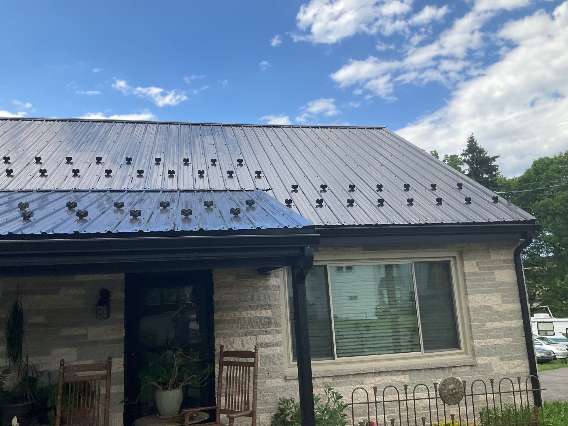 Metal Roofing, Board & Batten Siding, and Entry Door Transformation by Esh Builders