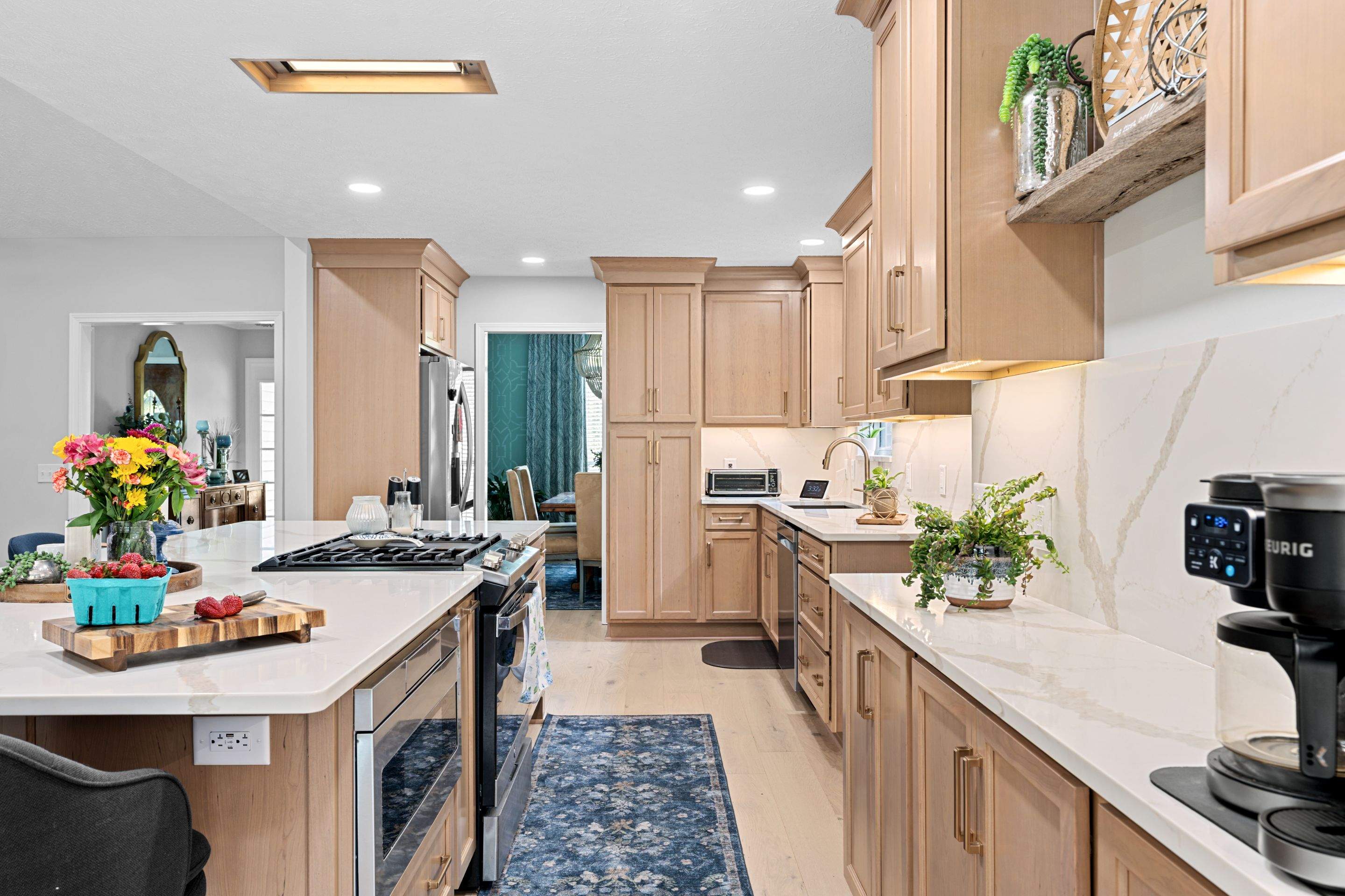 Modern Kitchen Remodel Featuring Quartz Backsplash, under cabinet lighintg, and a coffee bar in Mt. Juliet Tennessee by DeRo Renovations,LLC