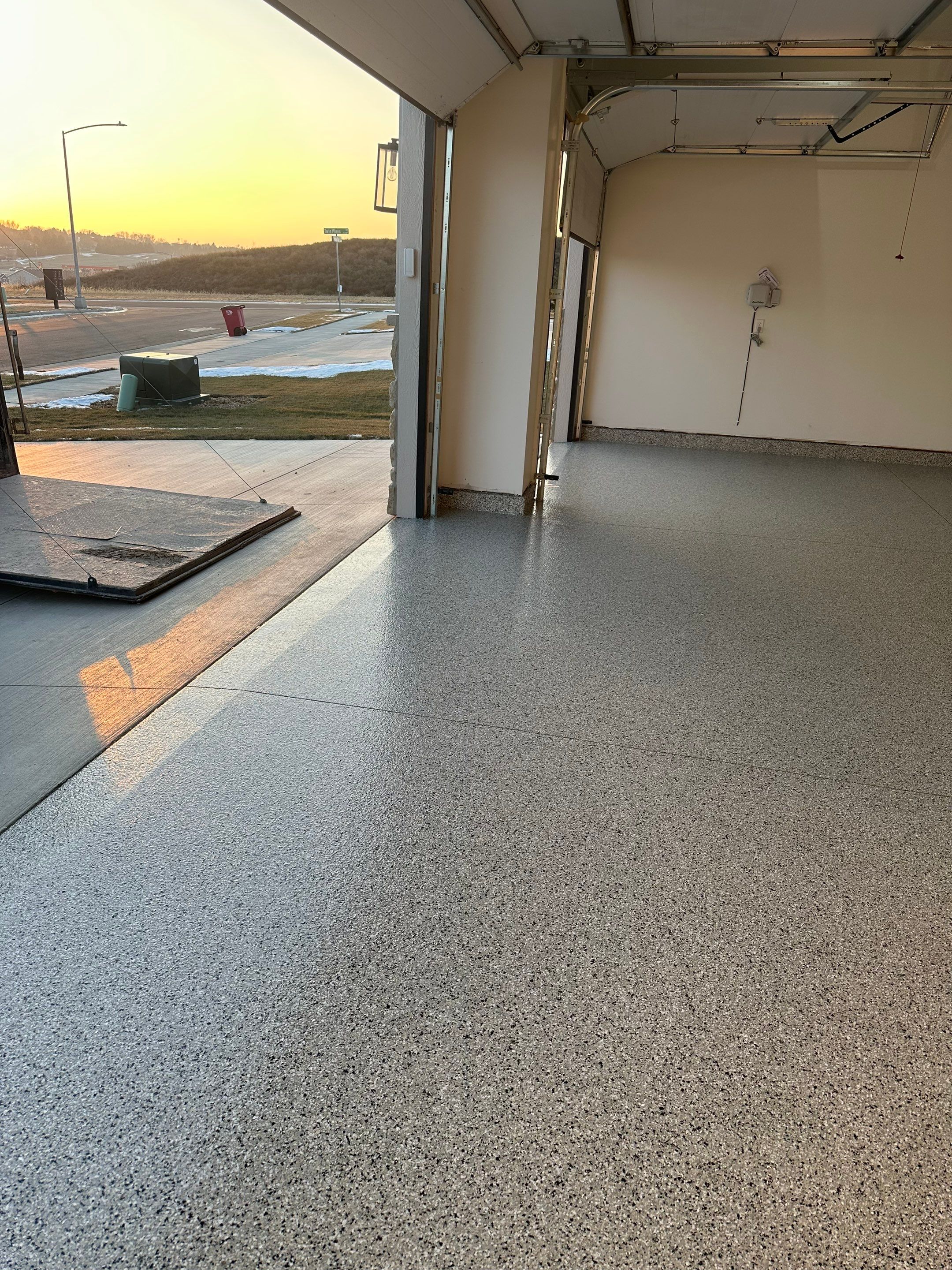 Cabin Fever Decorative Flake Garage Floor Coating in Sioux Falls by Select Painting, Coatings & Garage Cabinets