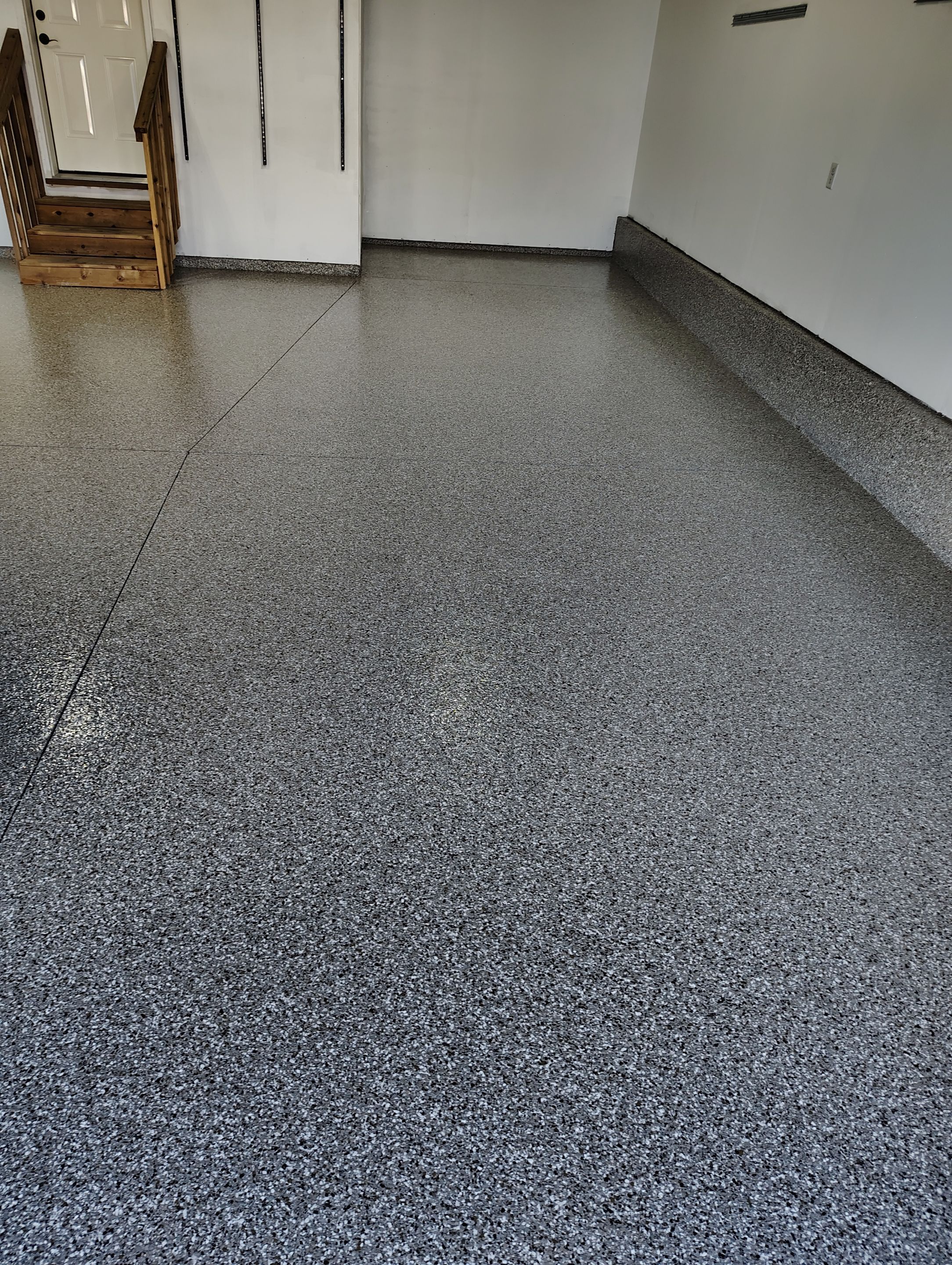 Sioux Falls Garage Floor Transformation With Gray Speckled Epoxy Coating by Select Painting, Coatings & Garage Cabinets