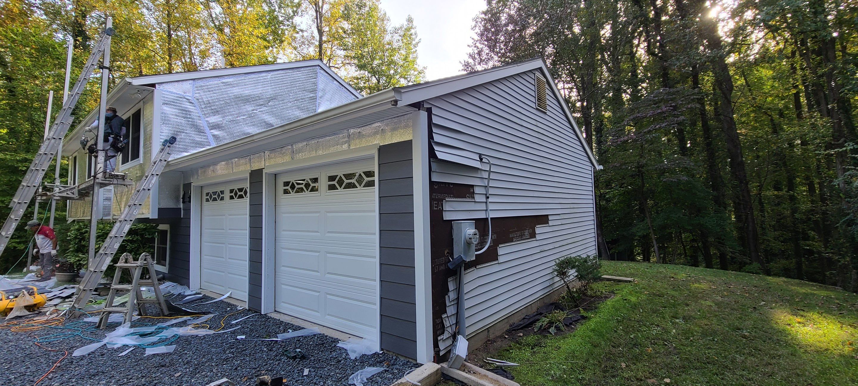 New James Hardie siding in Night Gray and Arctic White trim with LowE Wrap by Window Depot of Annapolis