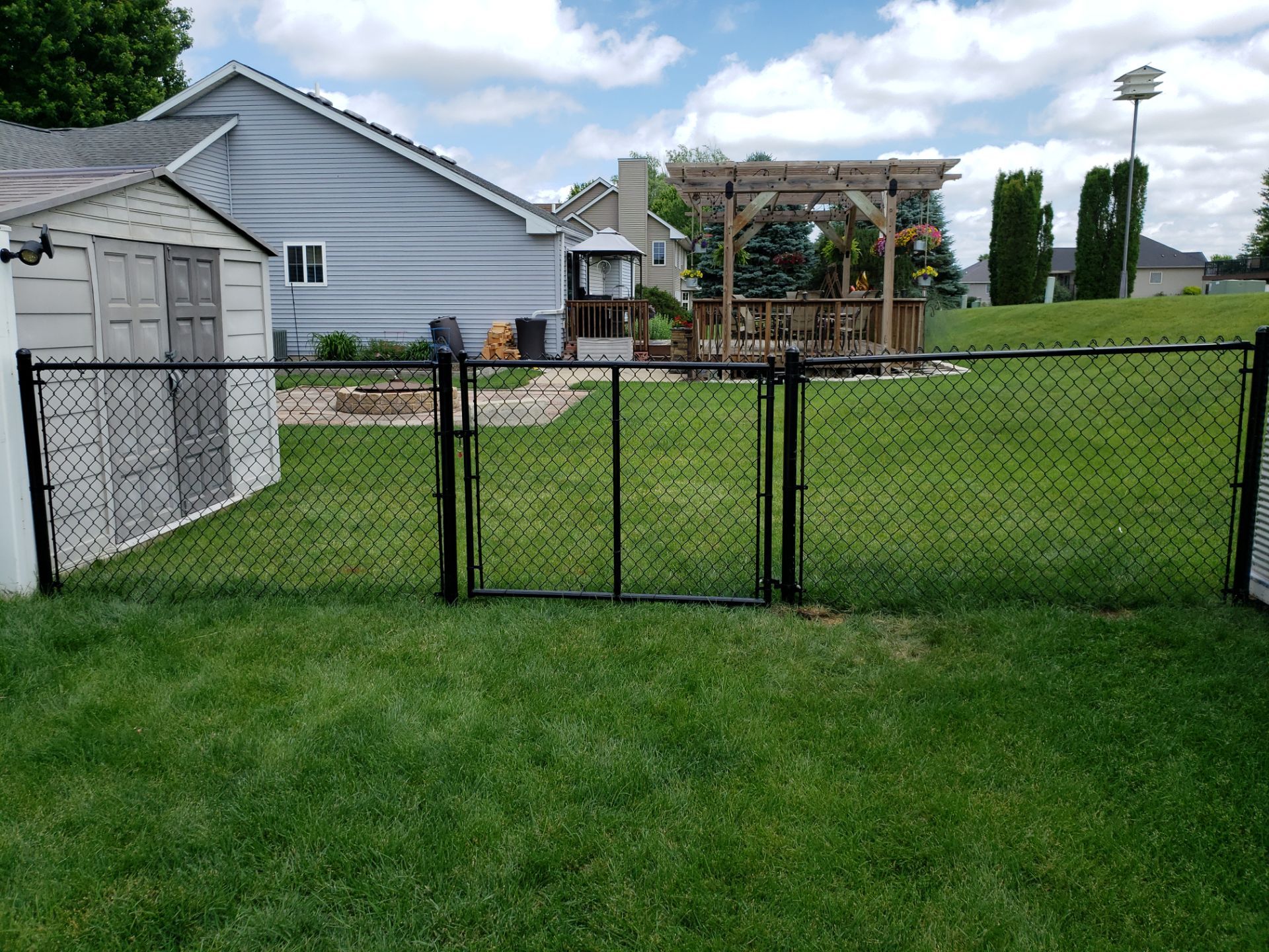Black Vinyl-Coated Chain Link Fence Installation in Denver by Perfect Picket Fence and Stain