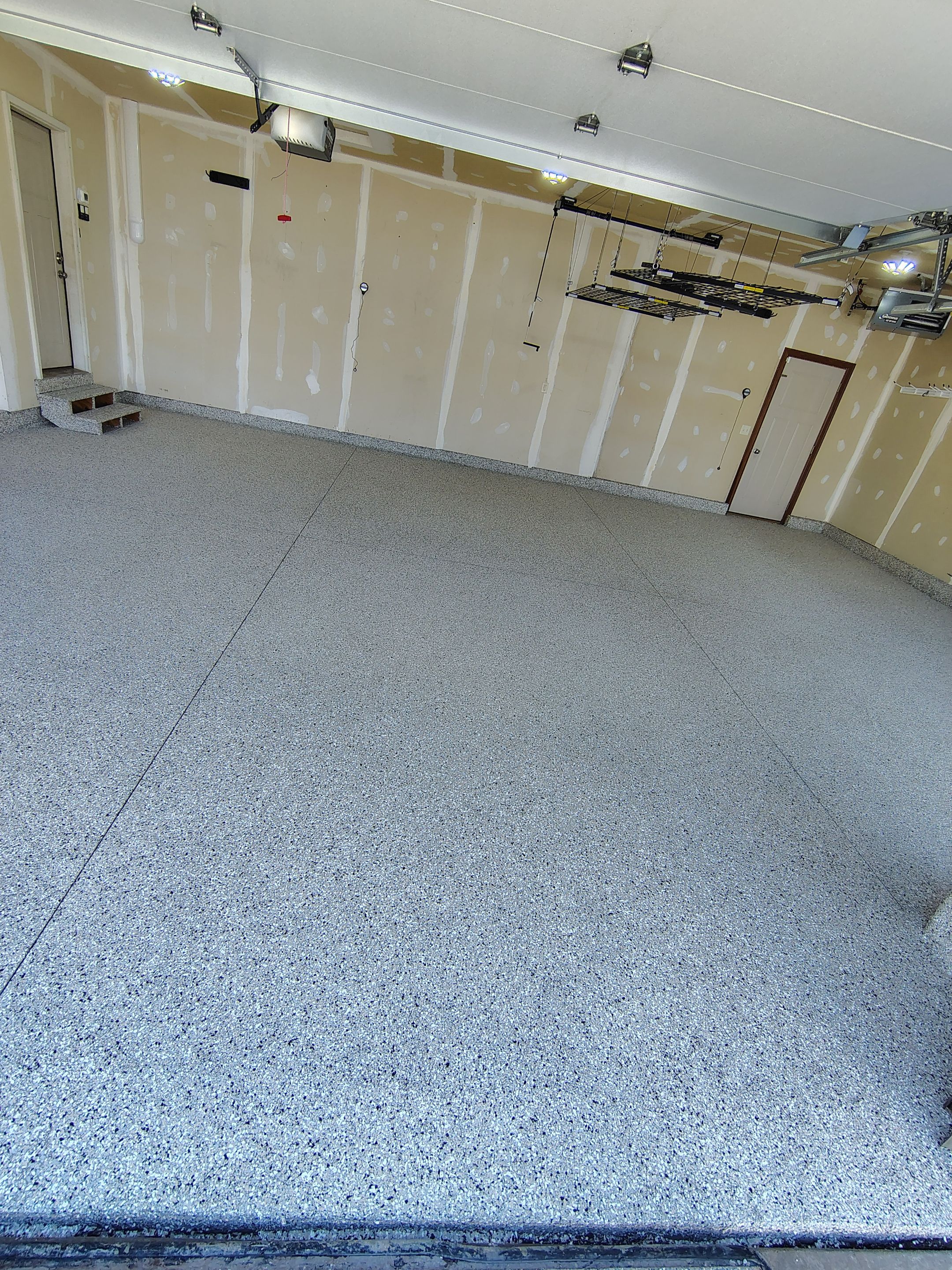 Multi-Car Garage Concrete Coating and Epoxy Finish in Sioux Falls by Select Painting, Coatings & Garage Cabinets