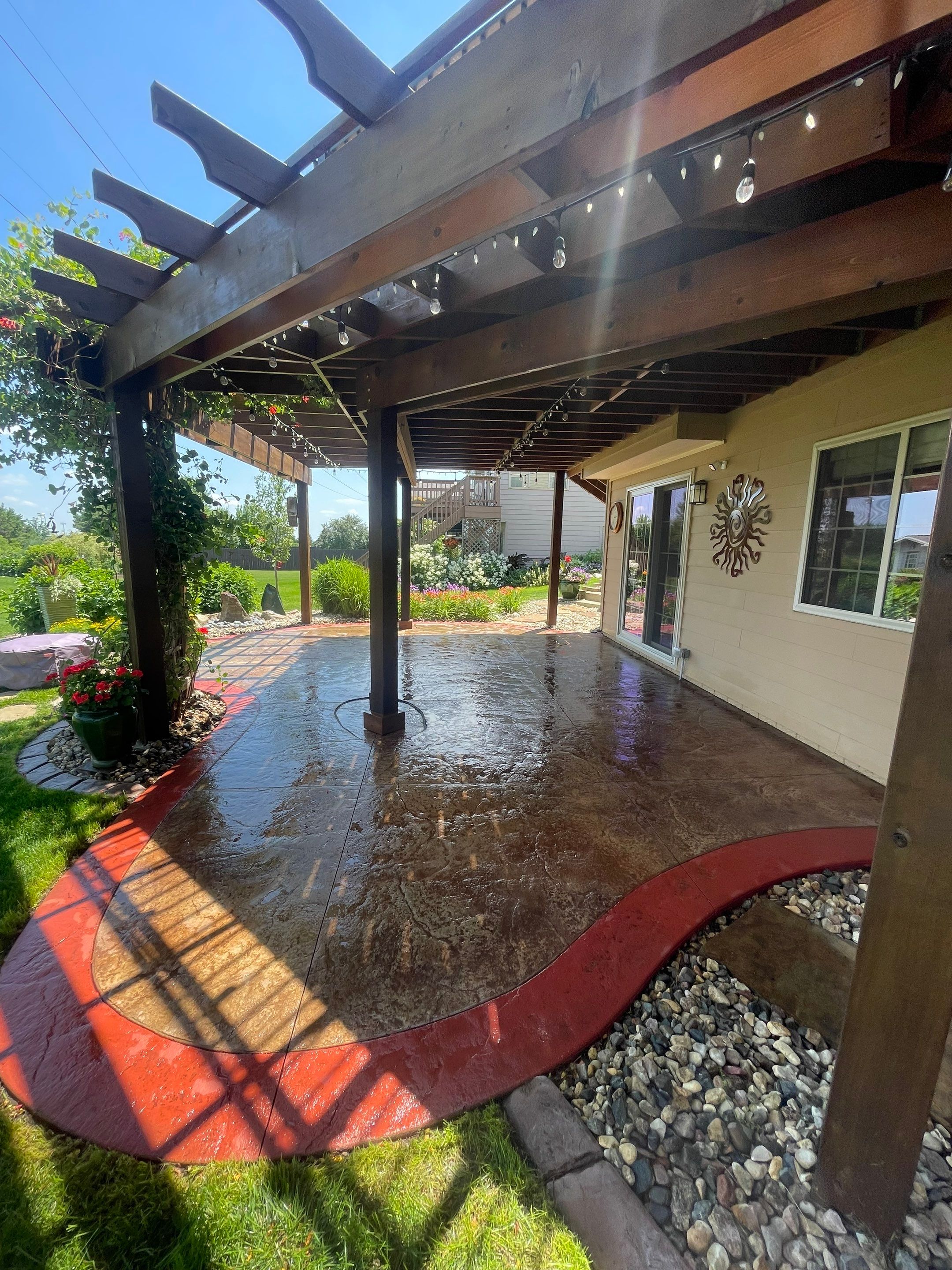 Custom Stamped Concrete Patio and Wood Pergola in Sioux Falls by Select Painting, Coatings & Garage Cabinets