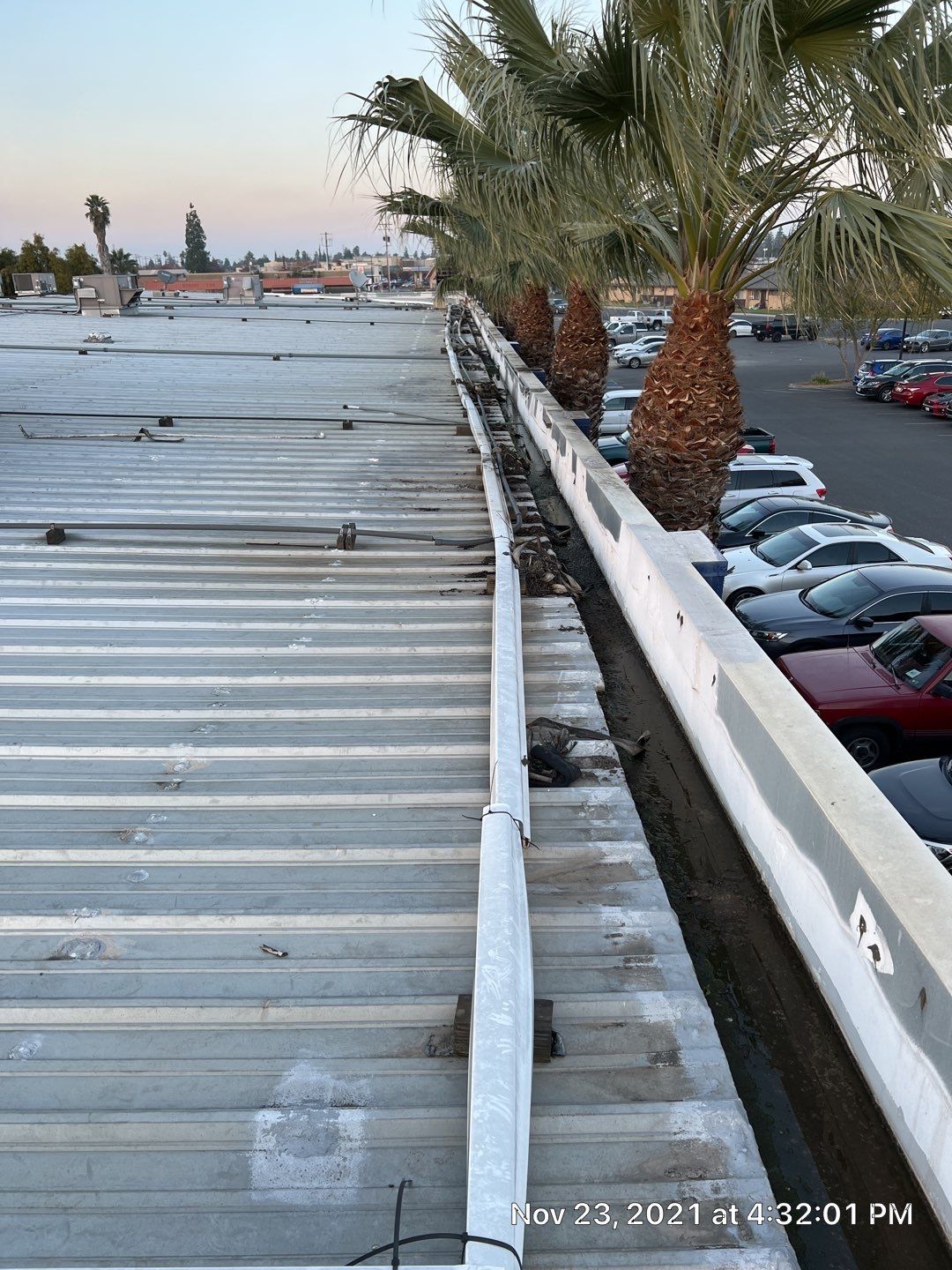Metal roof restoration on commercial roof using Conklin Benchmark/ PUMA XL acrylic coatings over metal and foam by Straight Edge Roofing Inc