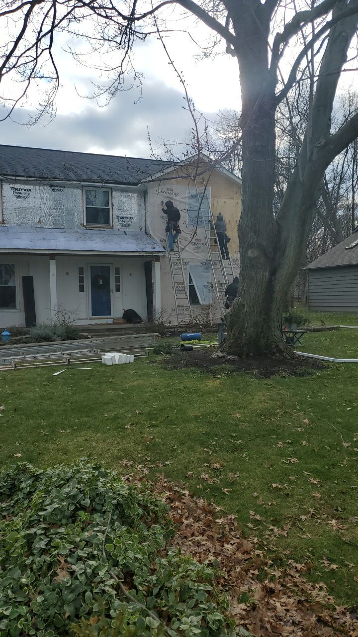 James Hardie Siding  using James Hardie Board and Batten, White by Absolute Roofing and Construction