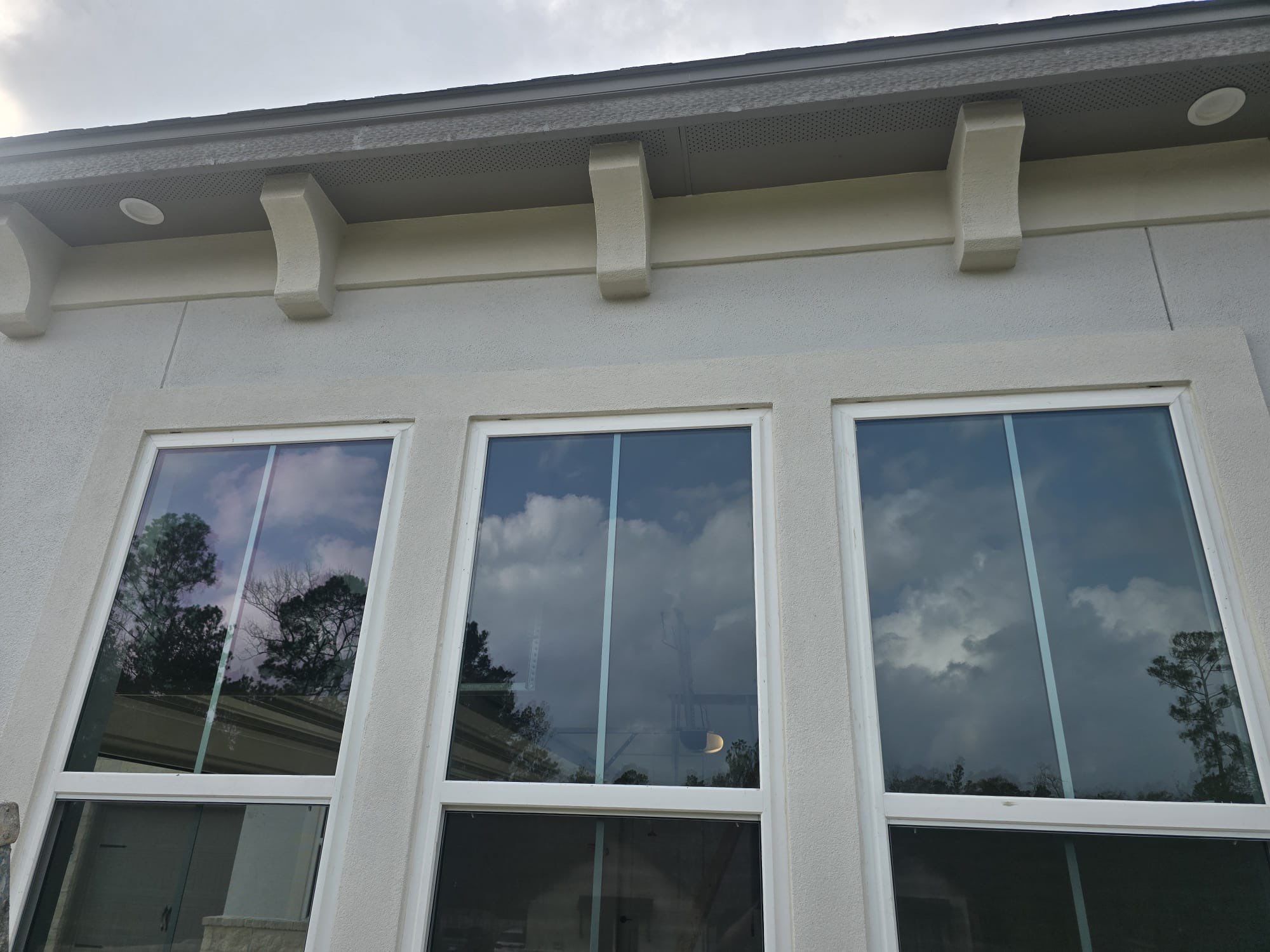Conroe Elegance: Stucco, Foam Corbels, and Natural Stone Accents. by Apex Conventional Stucco Llc