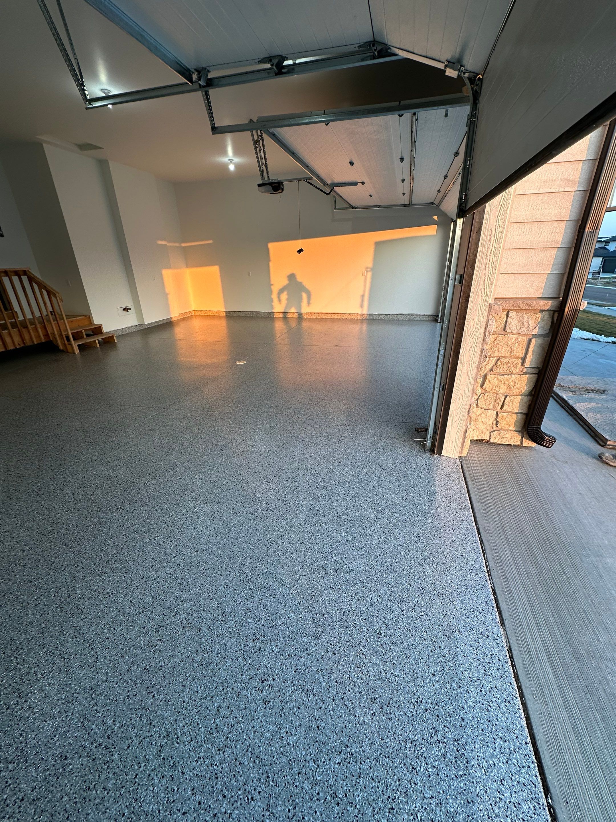 Cabin Fever Decorative Flake Garage Floor Coating in Sioux Falls by Select Painting, Coatings & Garage Cabinets