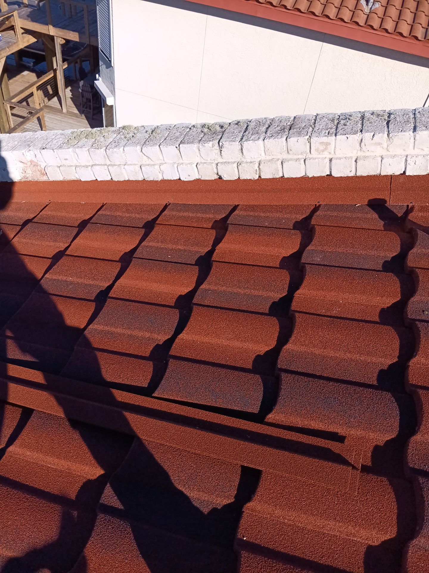 Off with the Tile and on with the TILCOR stone coated metal.  by Bayfront Roofing and Construction