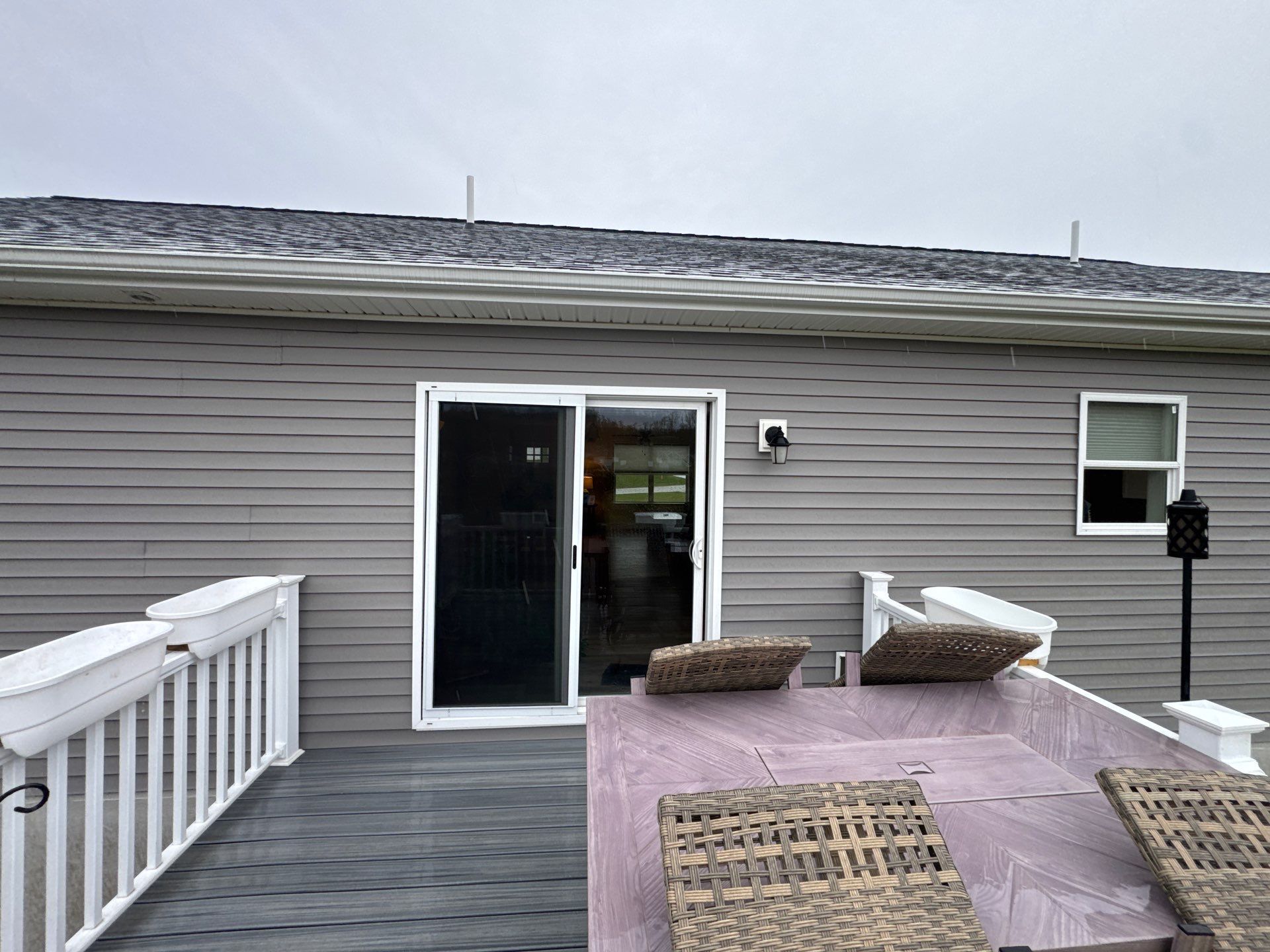 Sunesta Retractable Awning Installation Over Petoskey Home Deck by Rainbow Seamless Systems
