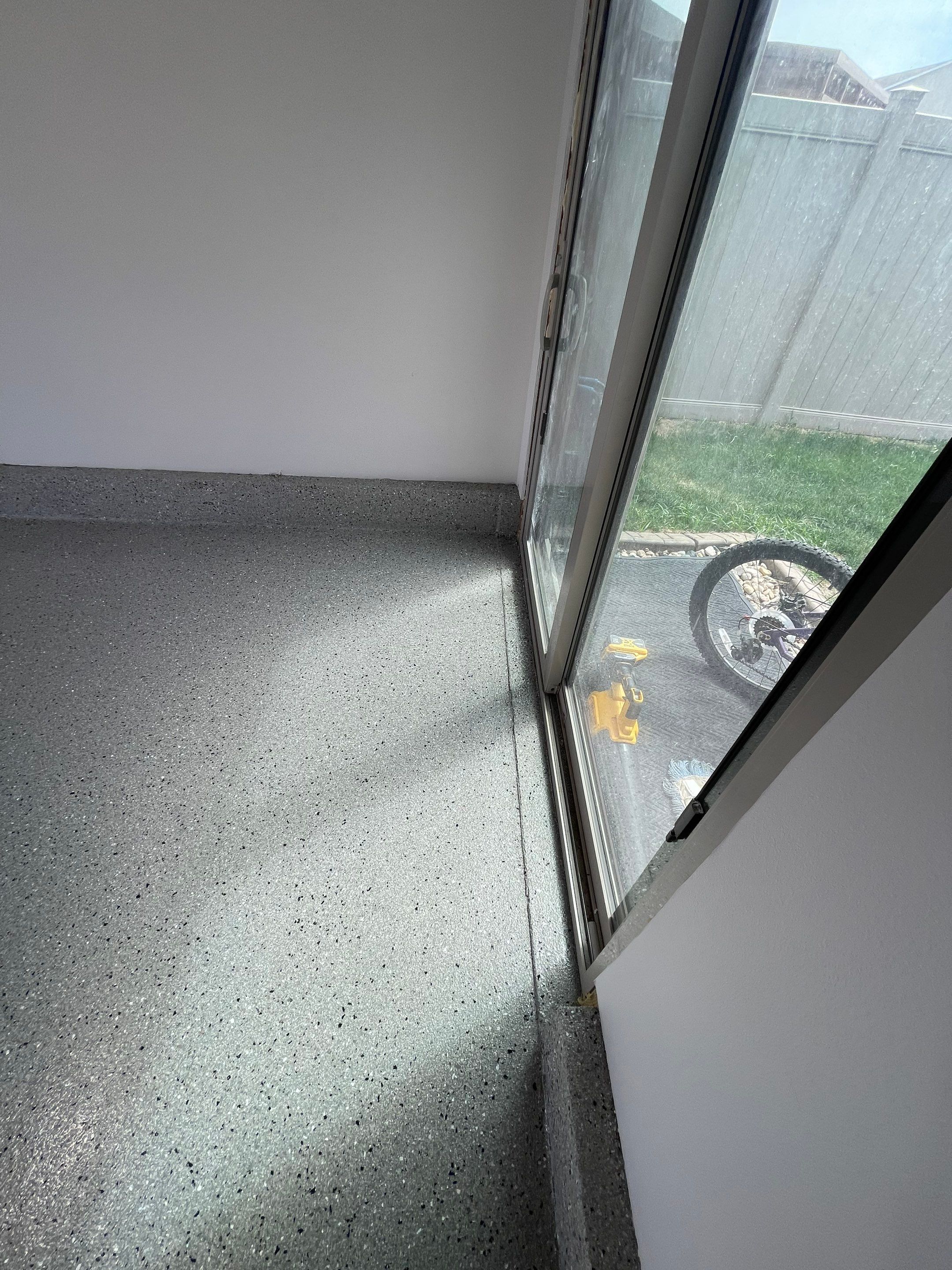 Residential Garage Floor Coating with Grey Speckled Epoxy Finish by Select Painting, Coatings & Garage Cabinets