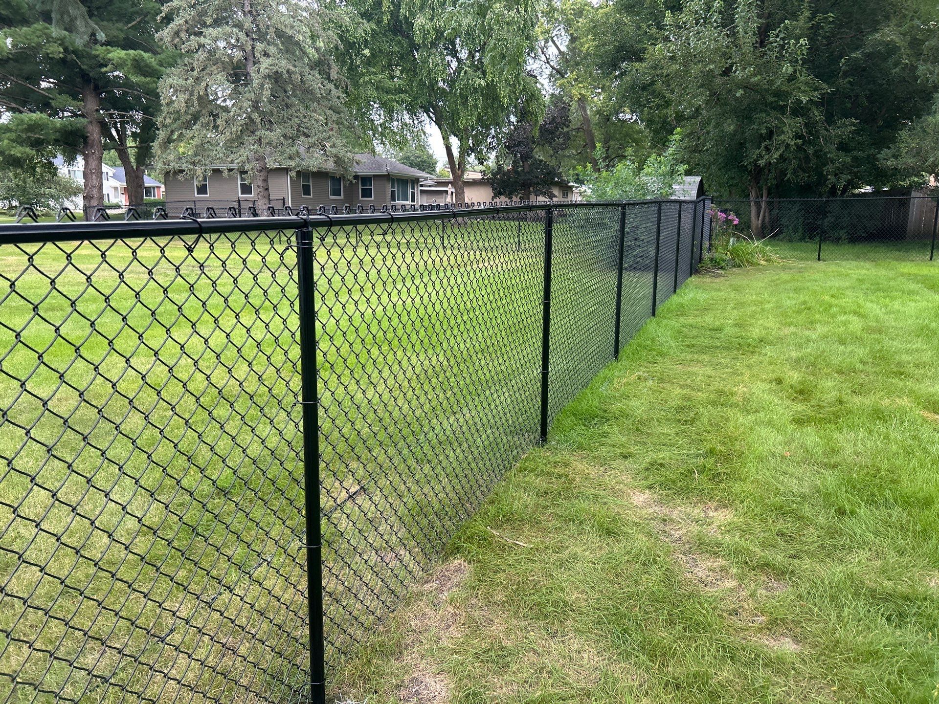 Black Vinyl Coated Chain Link Fence Installation in Waterloo by Perfect Picket Fence and Stain