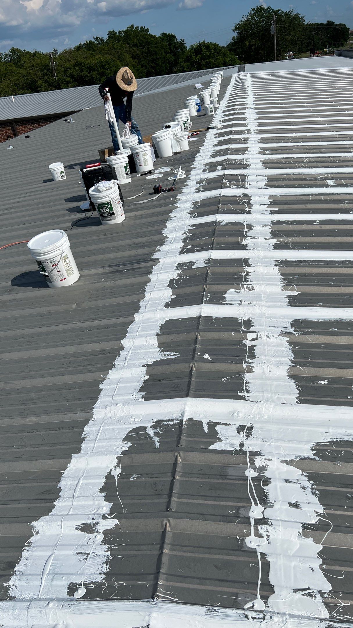 Commercial Roofing Installation using TRP #924 Eterna-Sil Premium Silicone Roof Coating by Harvey Roofing & Construction
