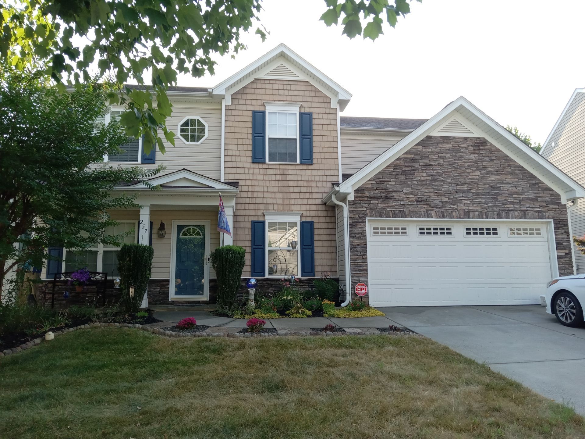 pressure washing company cleaning house exterior driveway sidewalk and possibly the roof