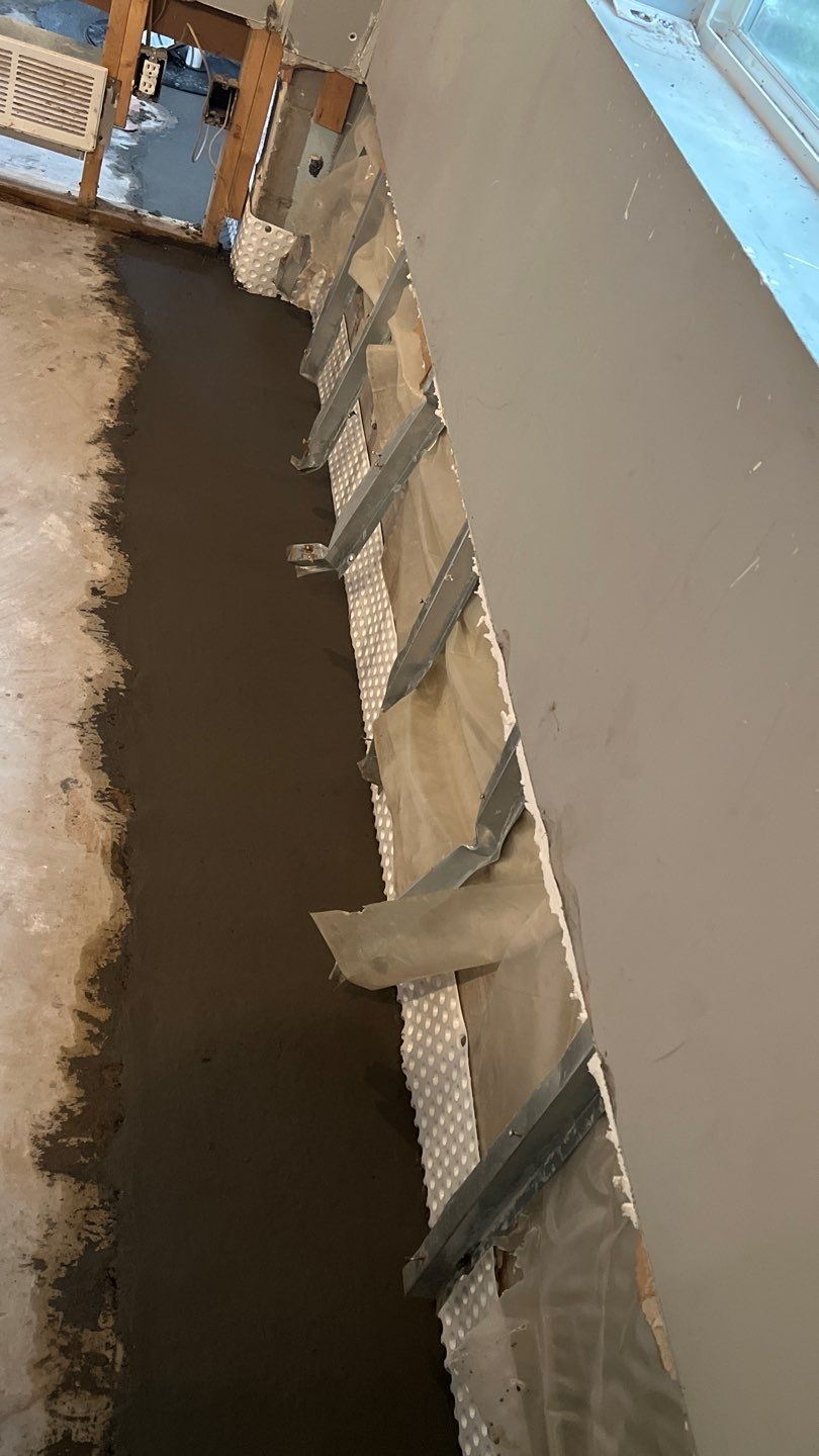 Interior drain tile system installation by ACE Waterproofing & Basement Solutions