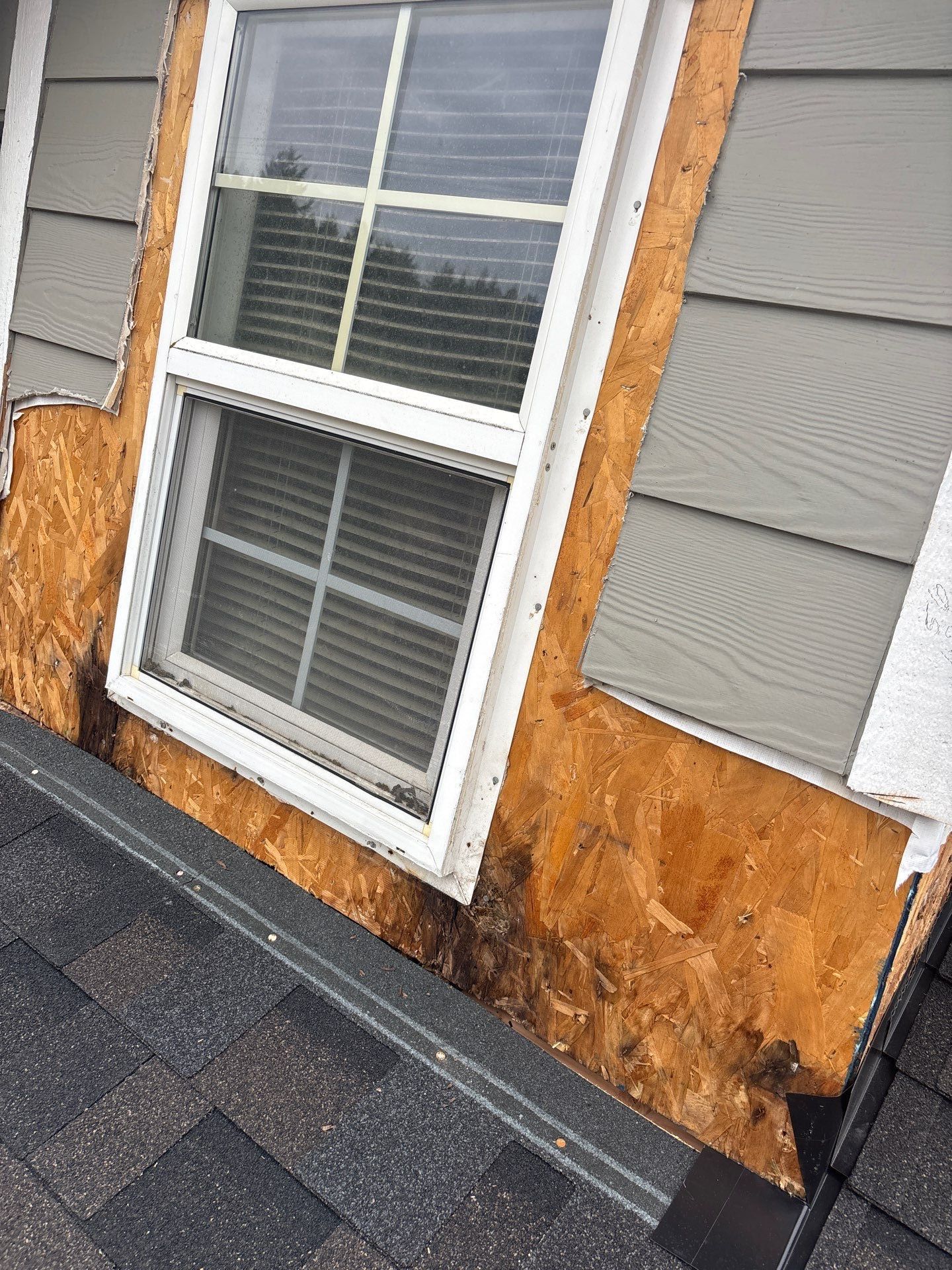 Residential Roof Replacement with Metal Accents by Orezona Building & Roofing Company, Inc.