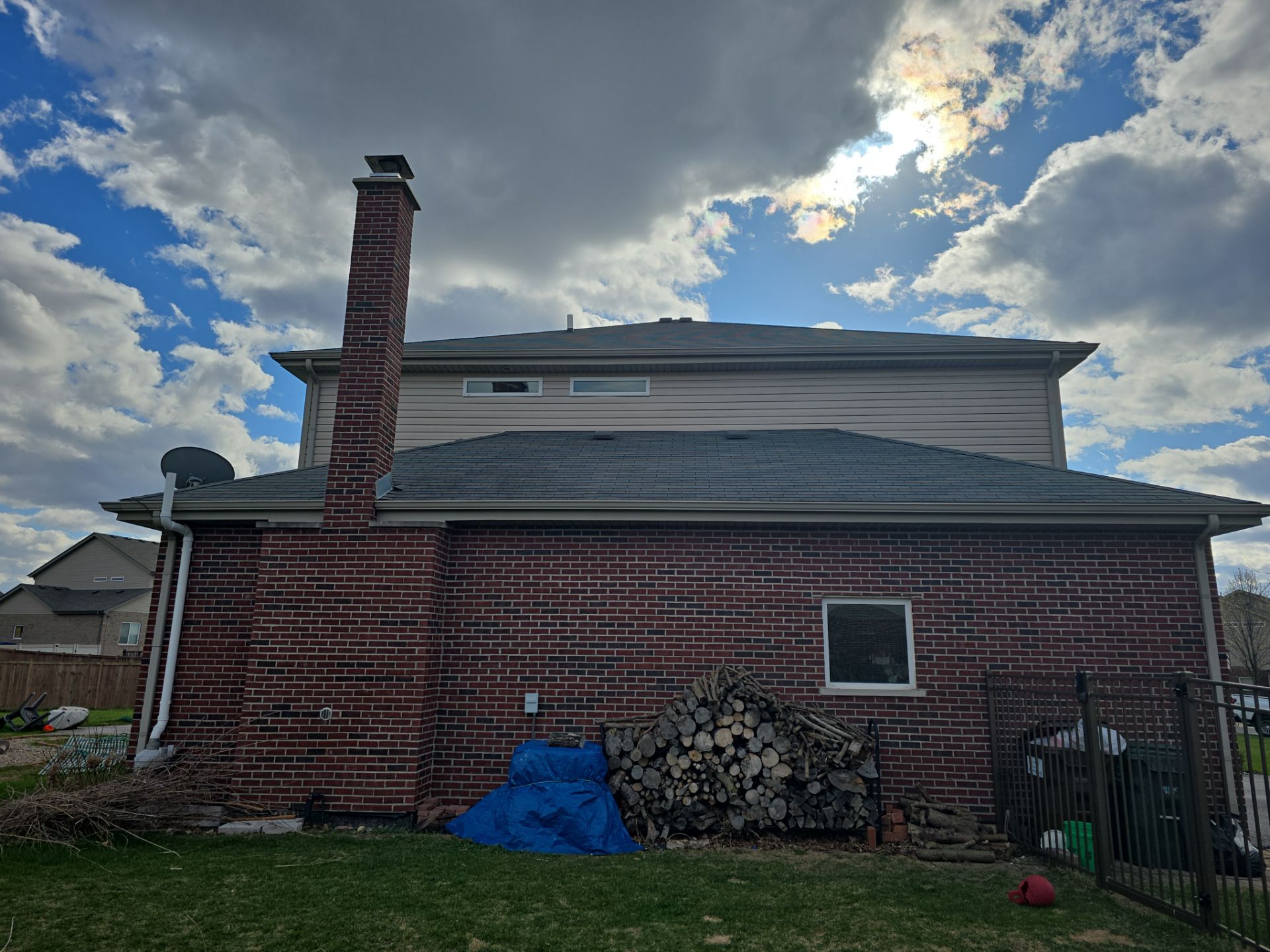 New black gutters and roof by Optimal Home Improvement 