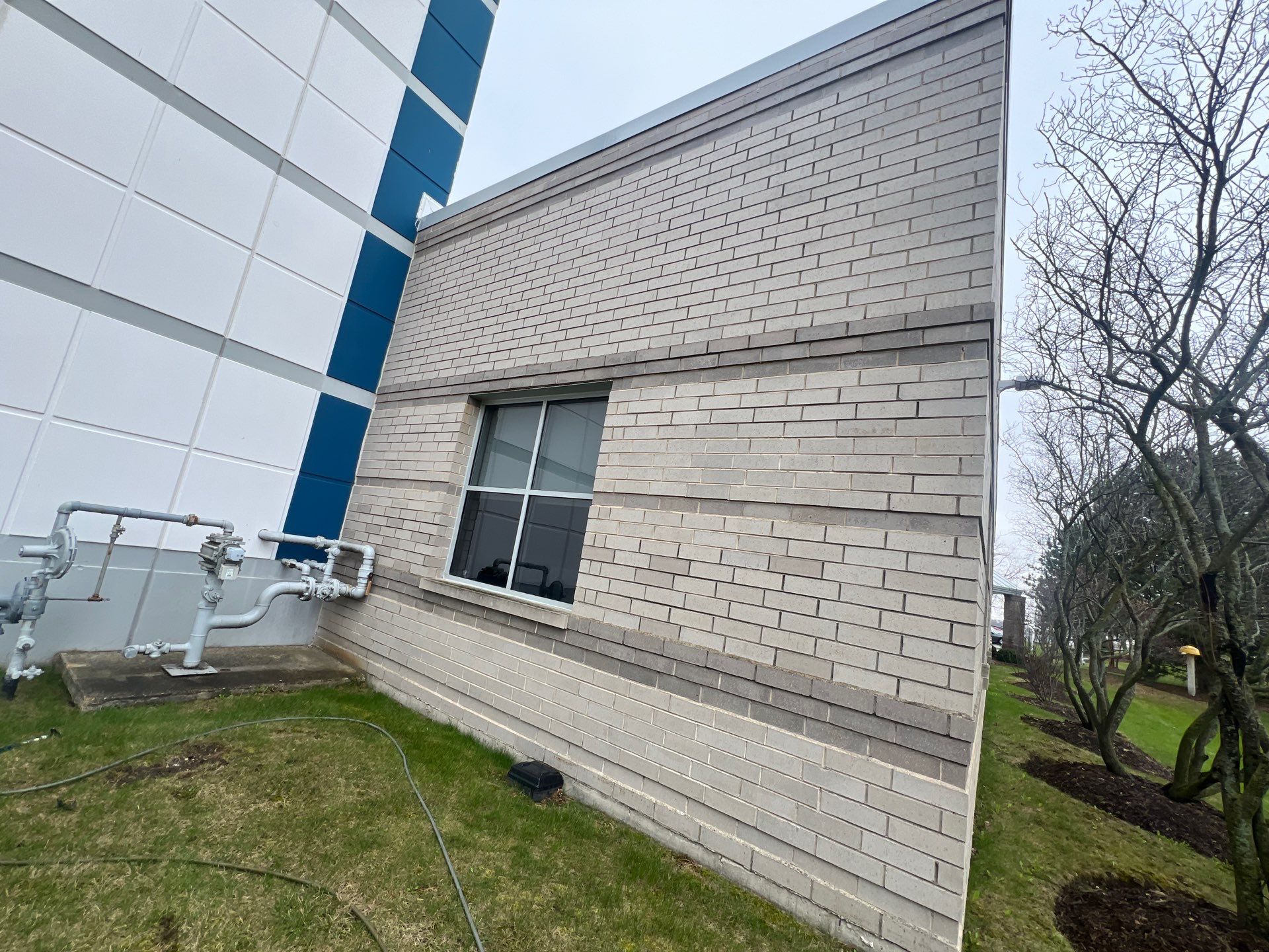 Commercial Facade cleaning using Algaecide, soft wash soap by Northern Power Washing LLC.