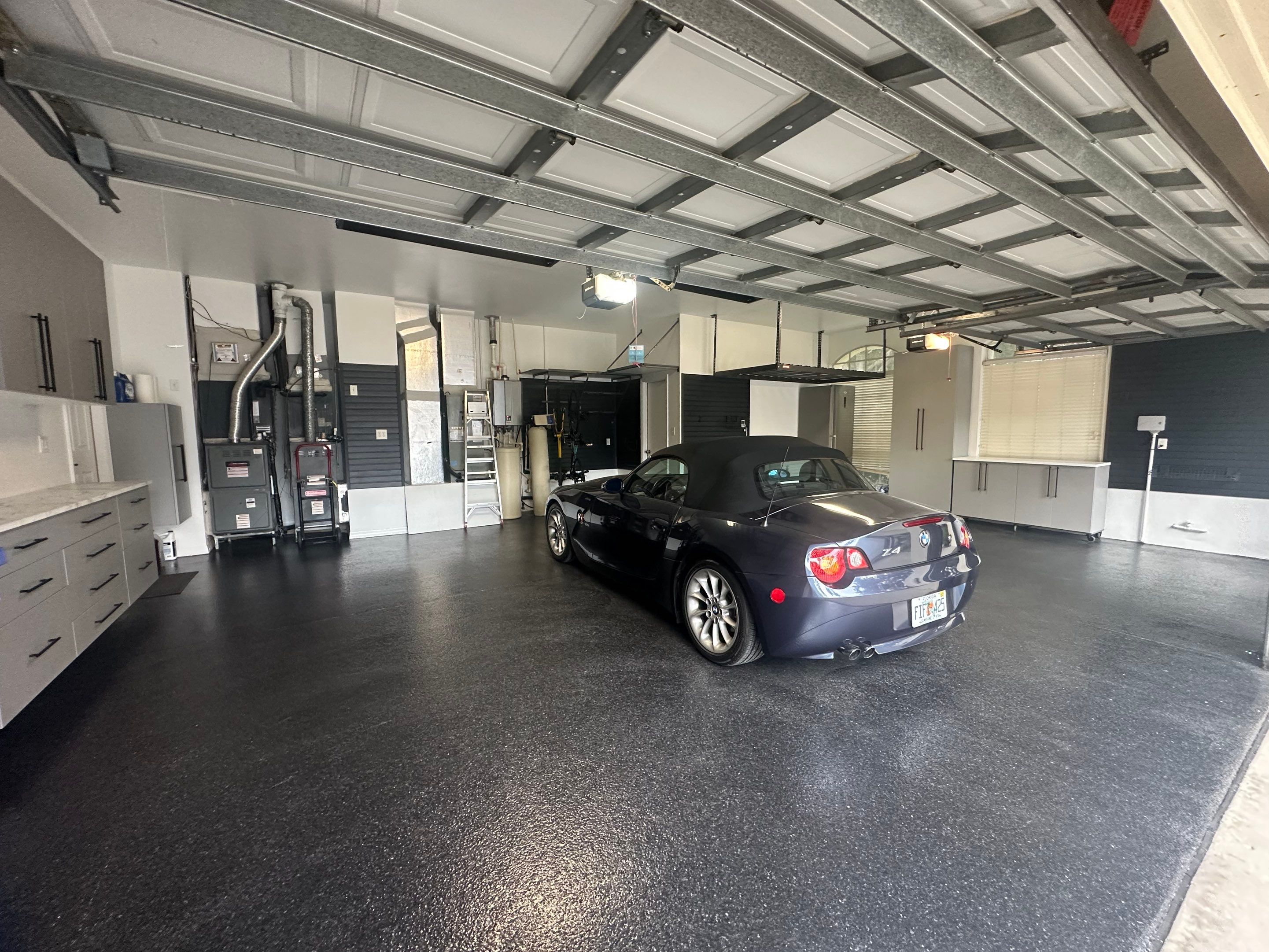 Tampa Garage Floor Coating and Overhead Storage Rack Installation by Square 1 Garage and Closet Solutions