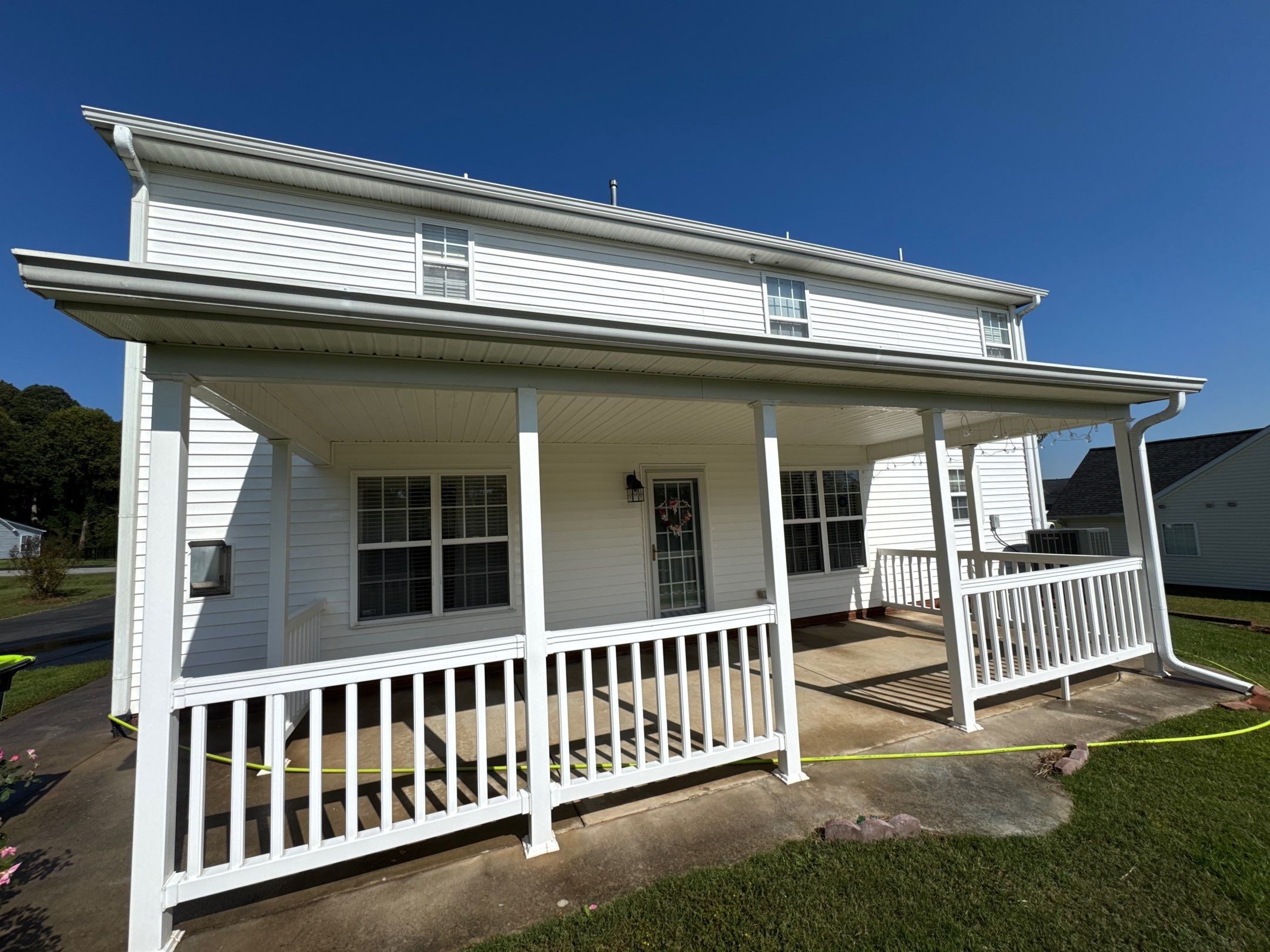 the service shown involves cleaning the exterior walls porch railings and concrete surfaces using pressure washing techniques