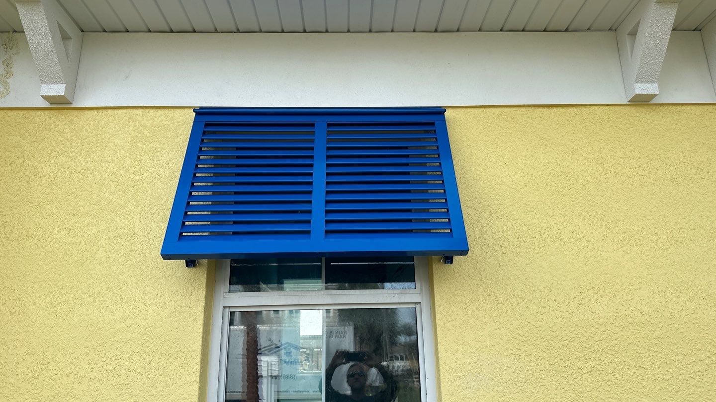 Bahama Shutters in Traffic Blue by Smart Guard Shutters