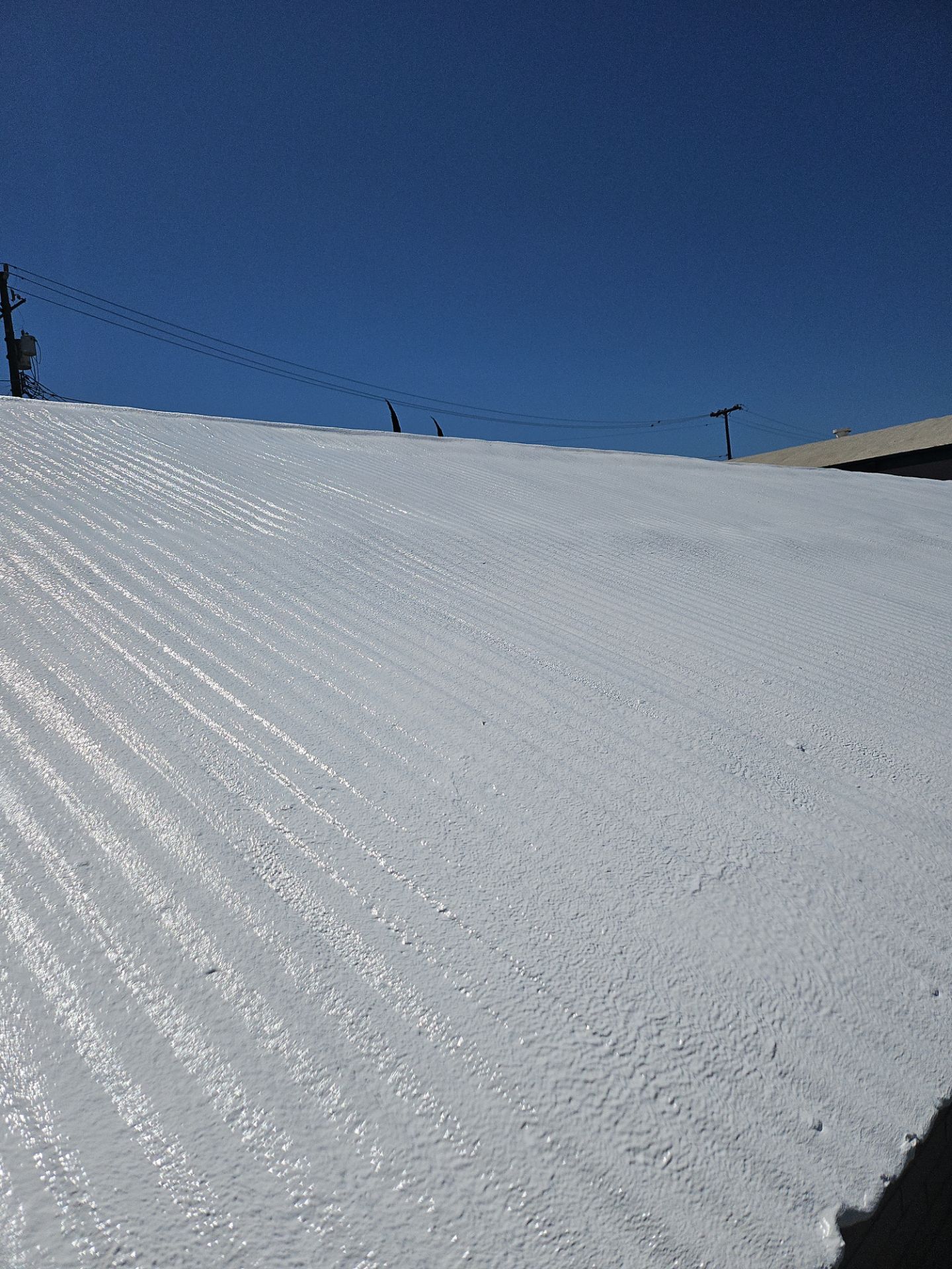 Spray foam and coatings using Conklin Benchmark/PUMA XL by Straight Edge Roofing Inc