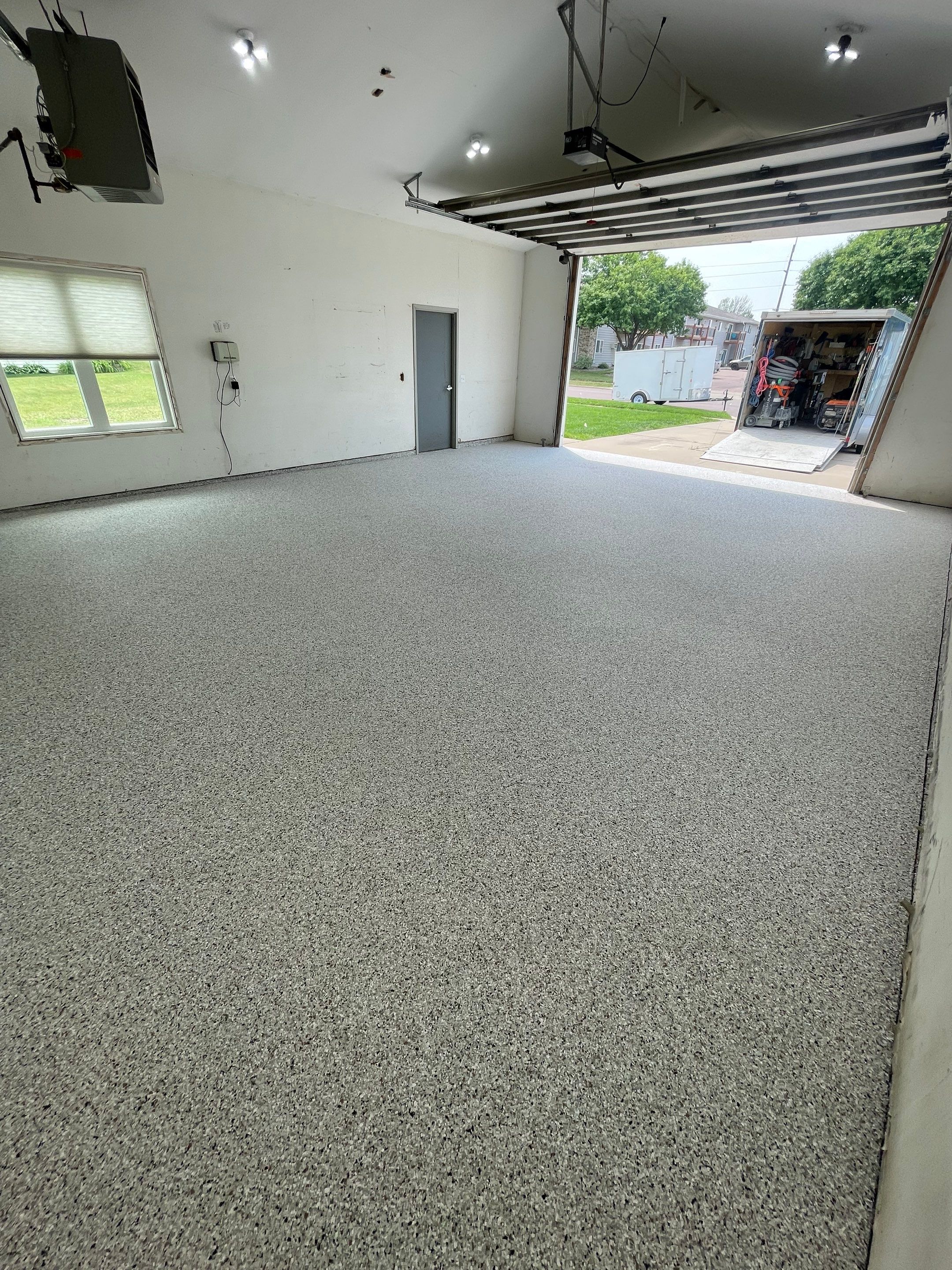 Coyote Flake Concrete Coating for Sioux Falls Garage by Select Painting, Coatings & Garage Cabinets