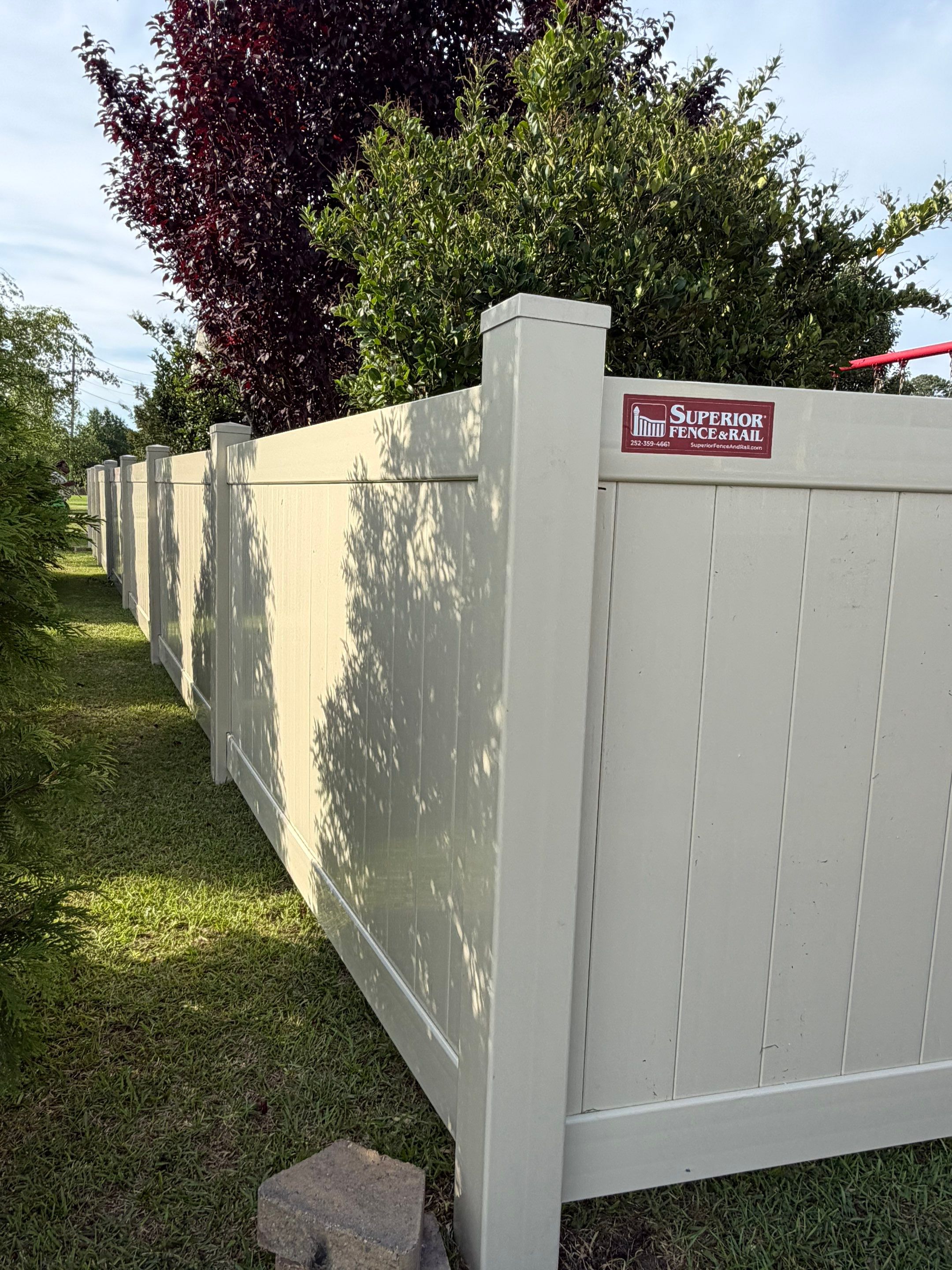 Residential Tan Vinyl Privacy Fence Installation in Winterville by Superior Fence and Rail