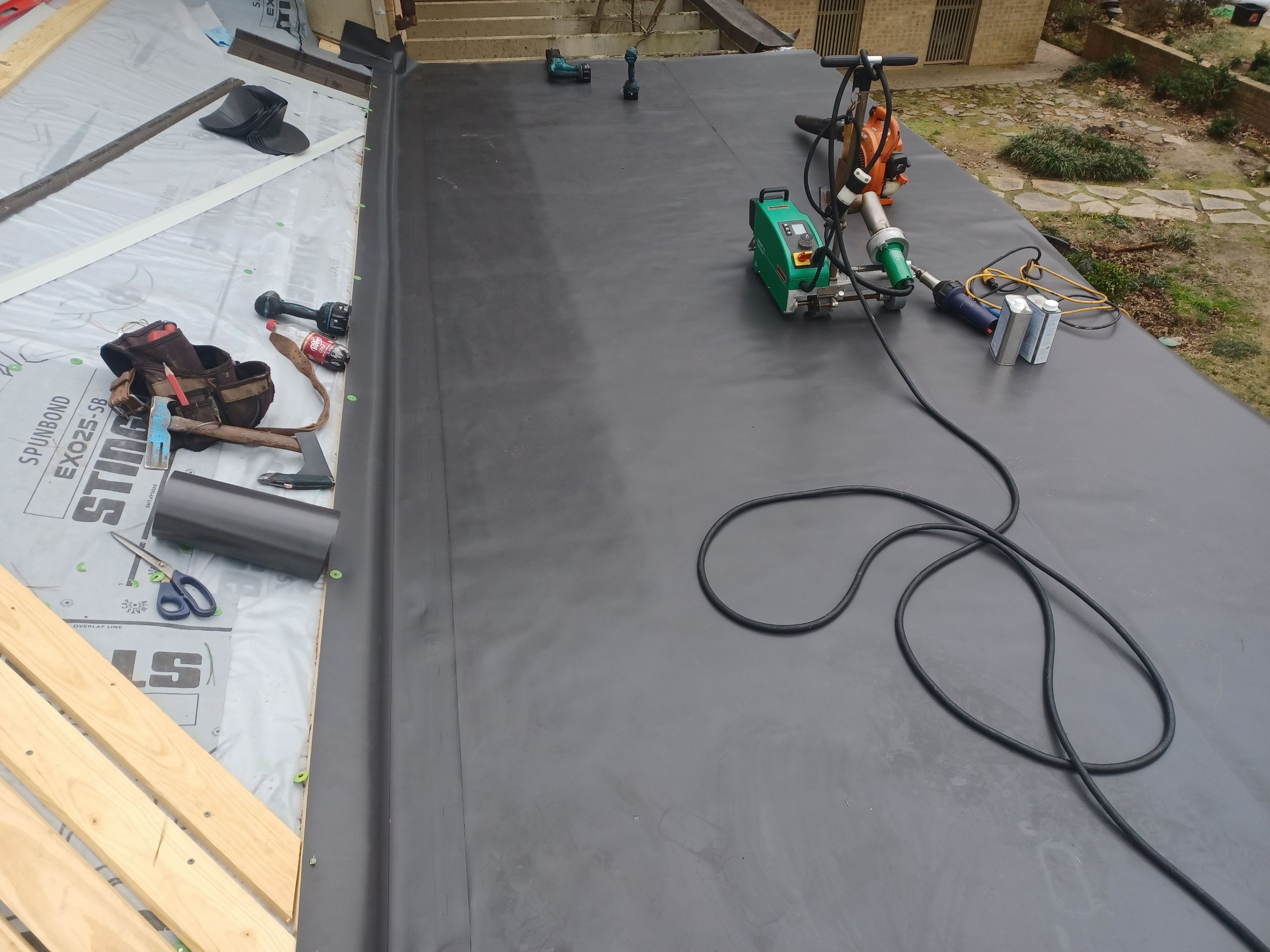Residential Roofing Installation using PVC membrane and 24 gauge Standing Seam Metal by Hostetler Roofing